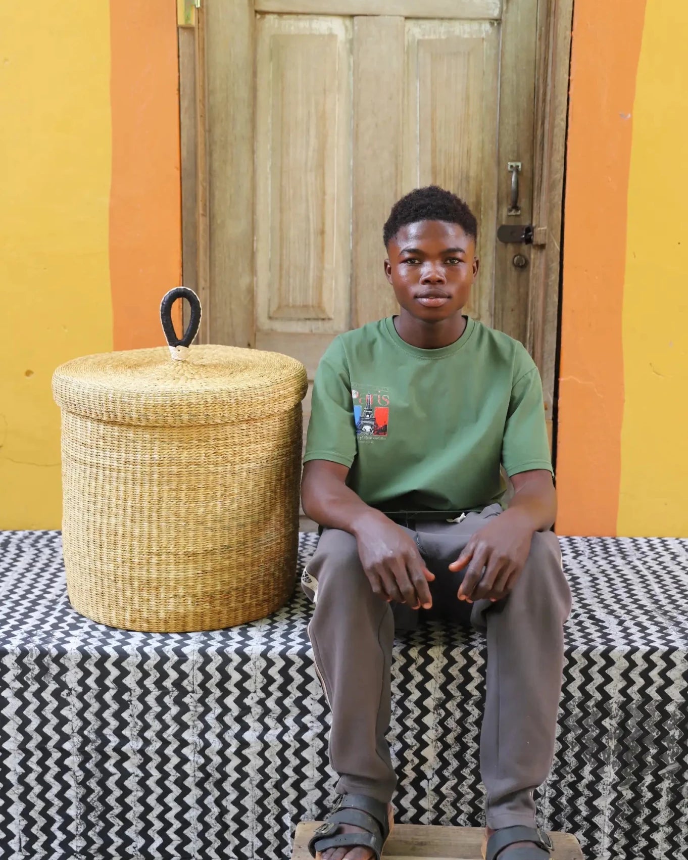 Lidded Laundry Basket (Medium) by The Baba Tree. Handwoven elephant grass with leather handle. Premium Bolgatanga artisan decor.