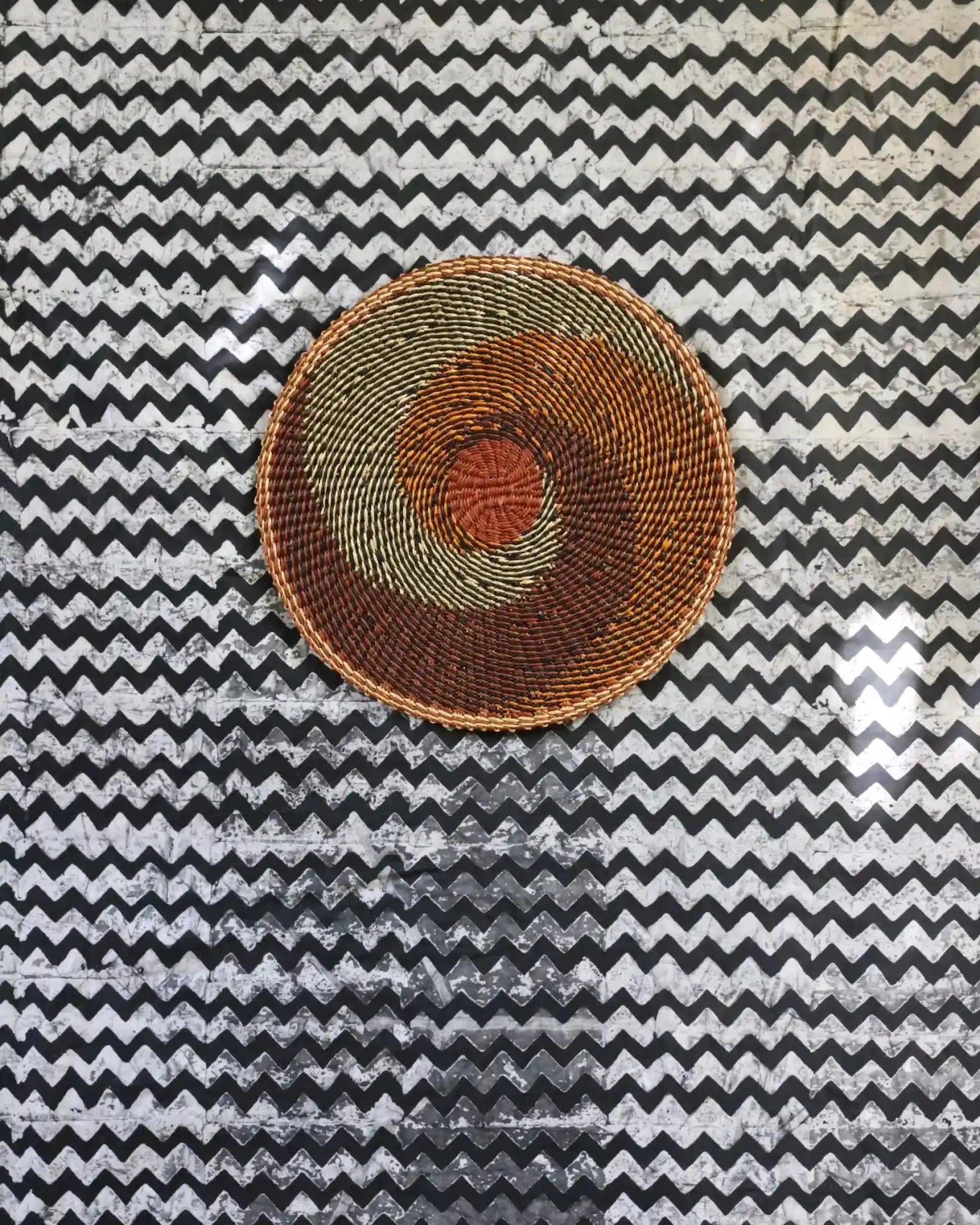 Woven placemat for dining on a black and white cloth