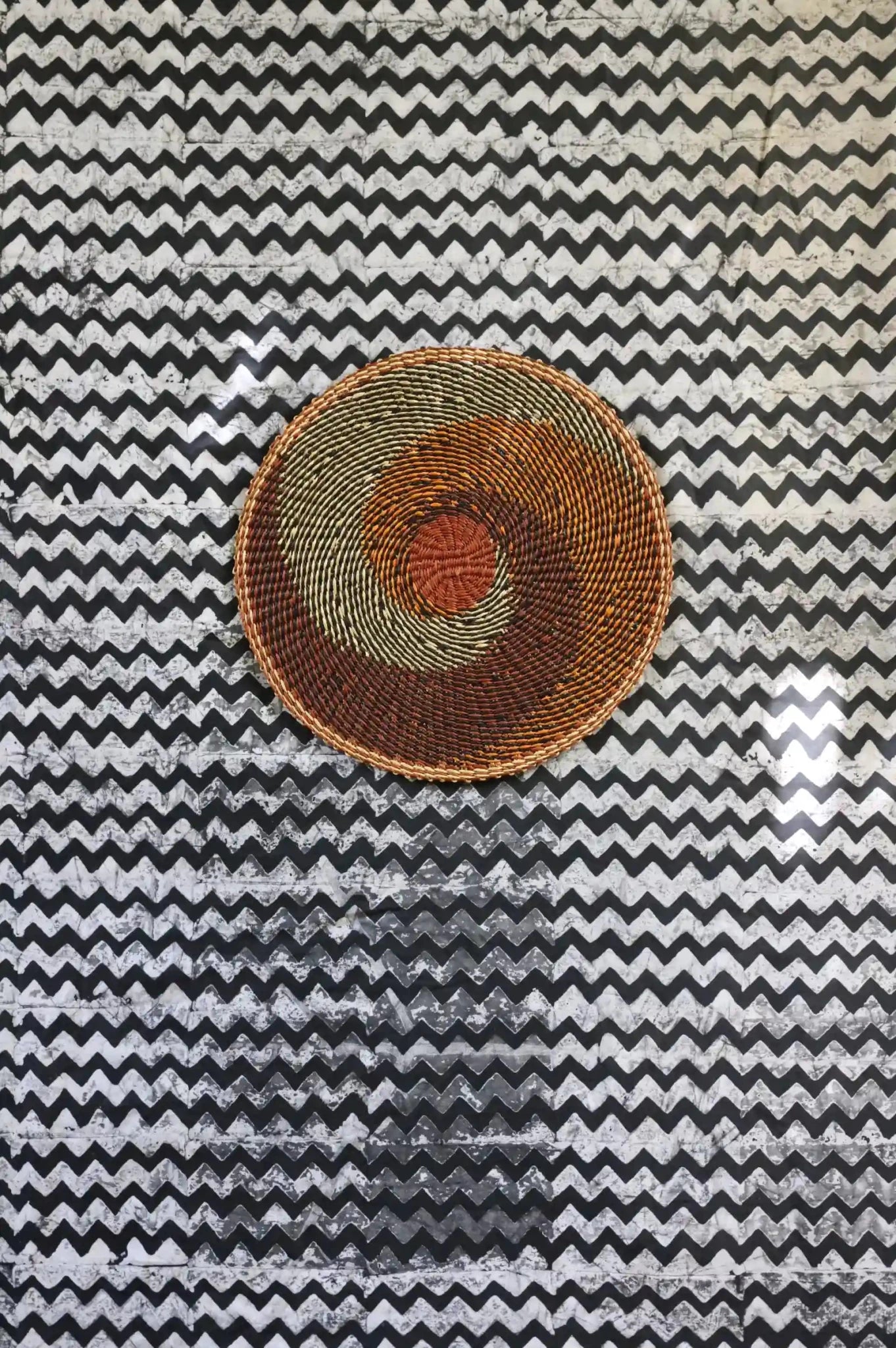 Woven placemat for dining on a black and white cloth