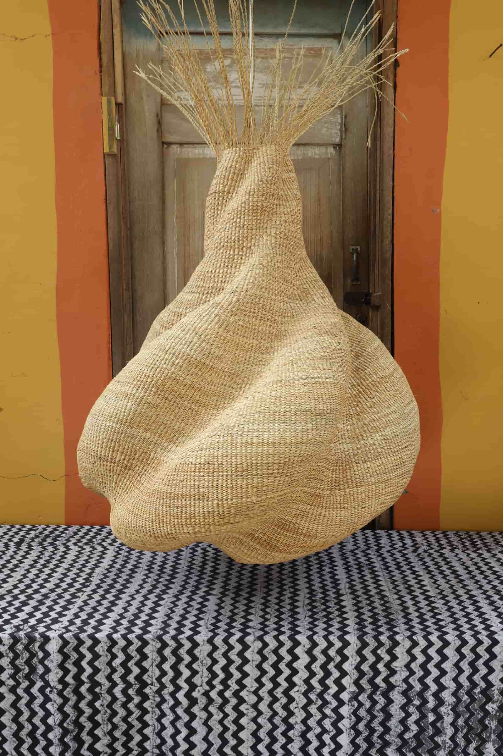 Woven basket on a striped surface with a colorful wall background