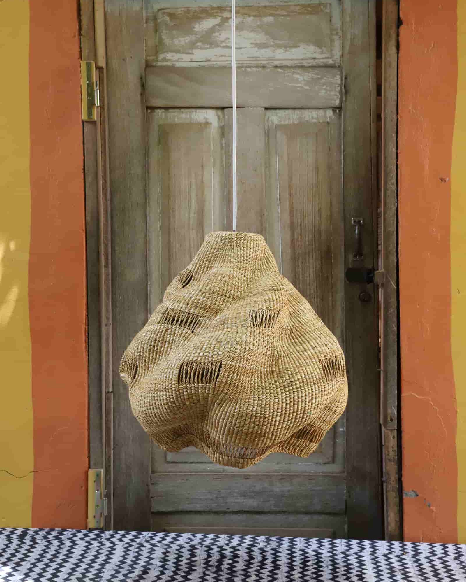 Woven basket hanging on a door with a colorful wall in the background