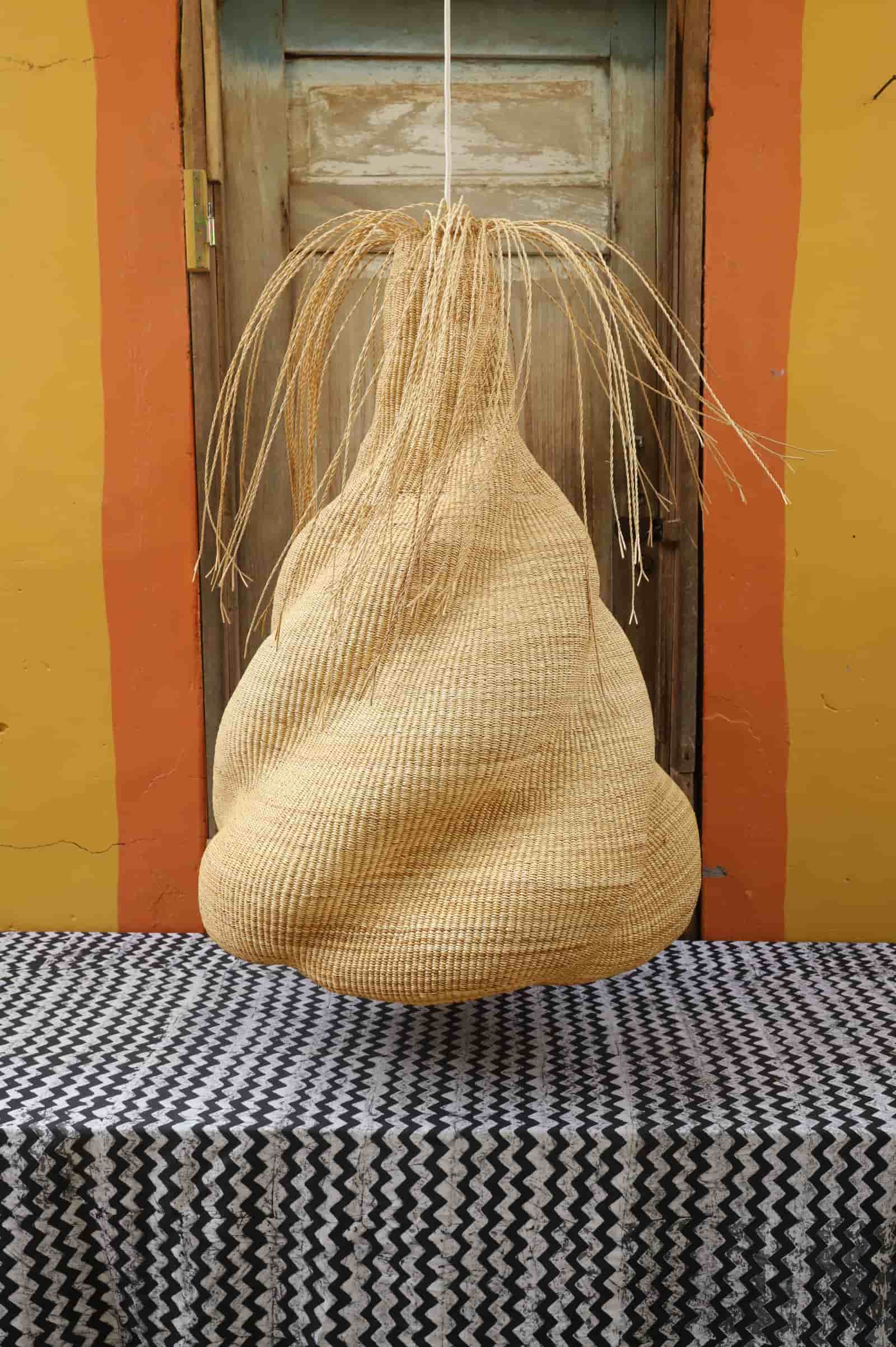 Woven basket hanging on a wall with a colorful background