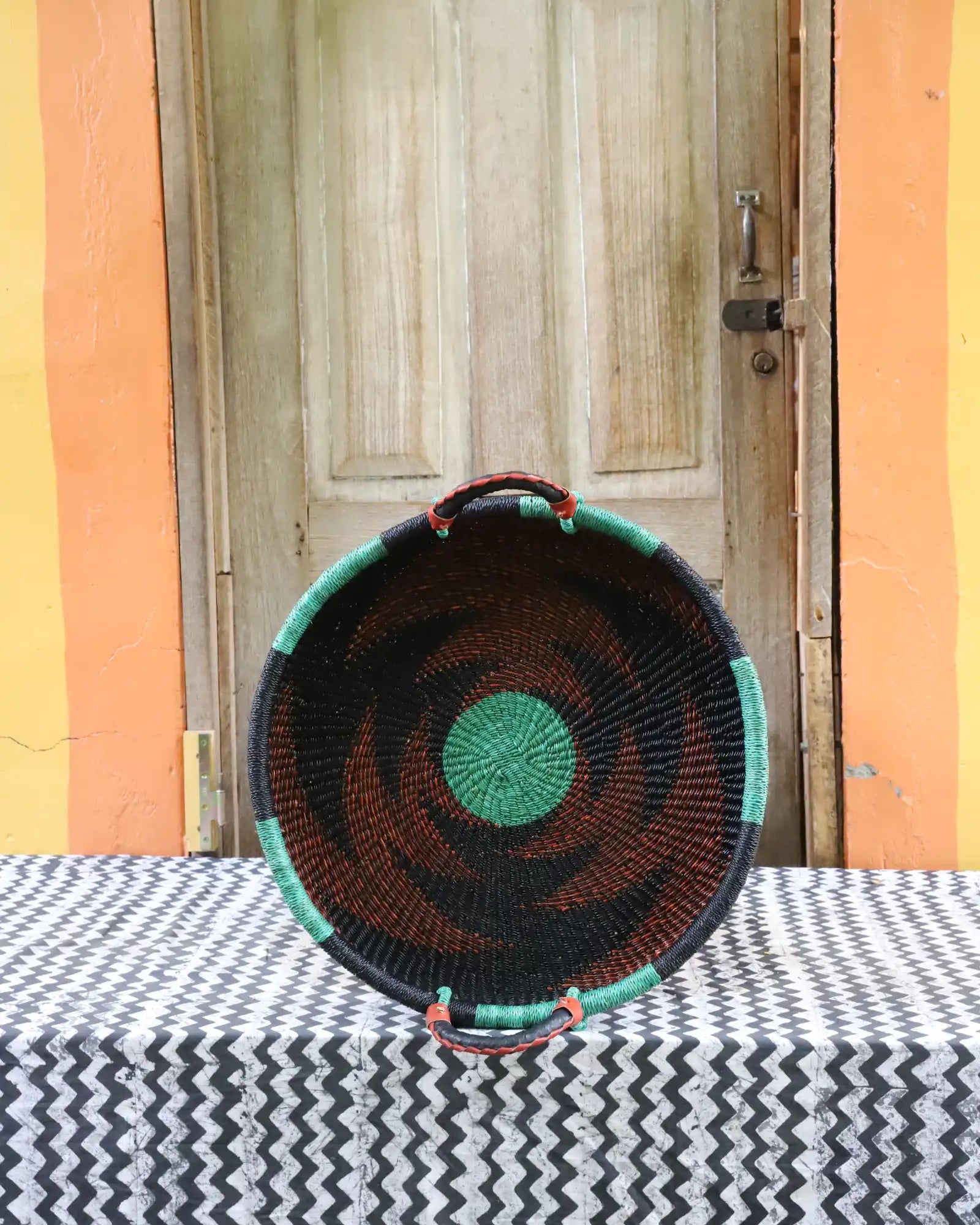 Woven Tray Wall Decor by The Baba Tree. Premium elephant grass tray with leather handles. Bolgatanga artisan craftsmanship.