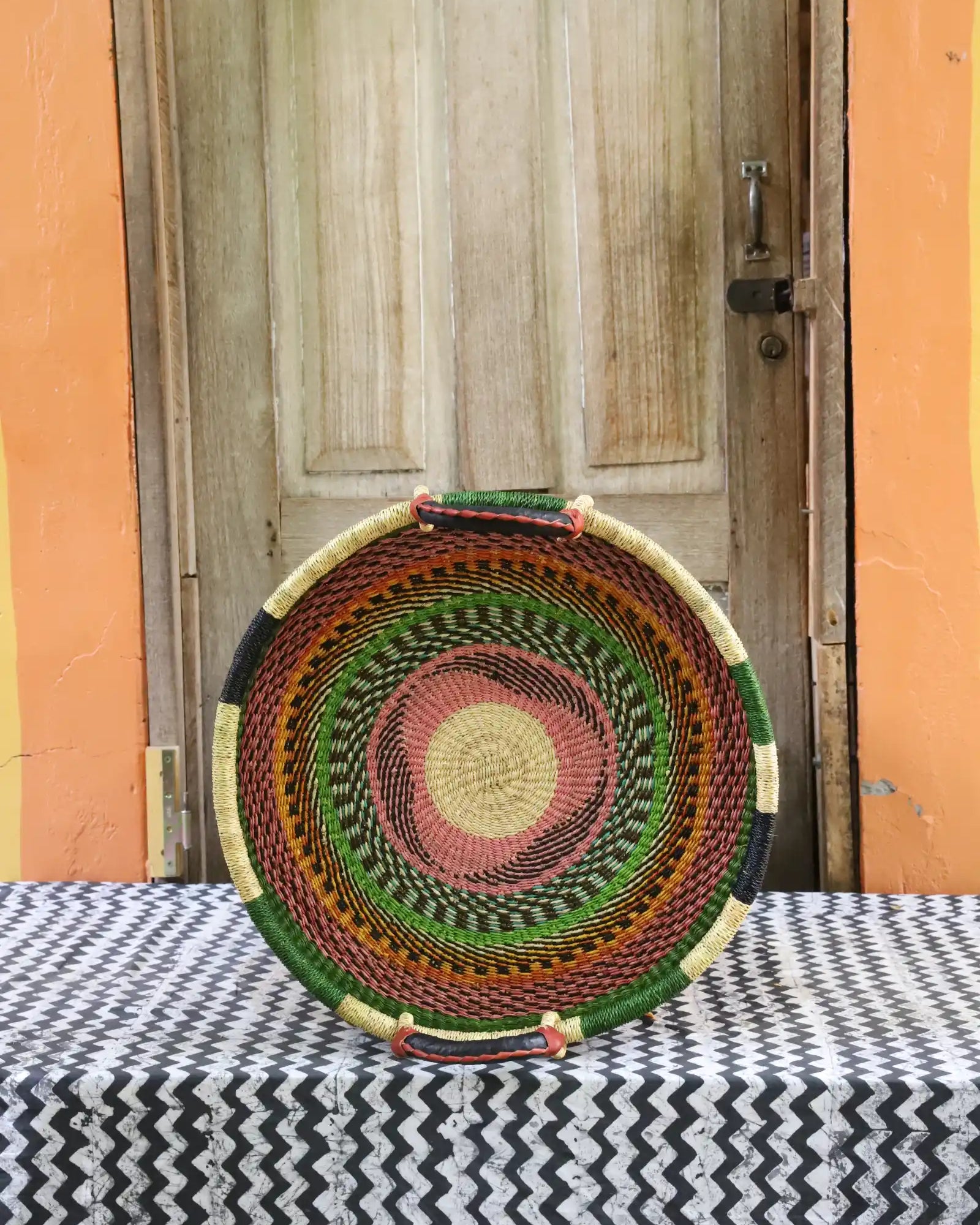 Woven Tray Wall Decor (small) by The Baba Tree. Premium elephant grass tray with leather handles. Bolgatanga artisan craftsmanship.