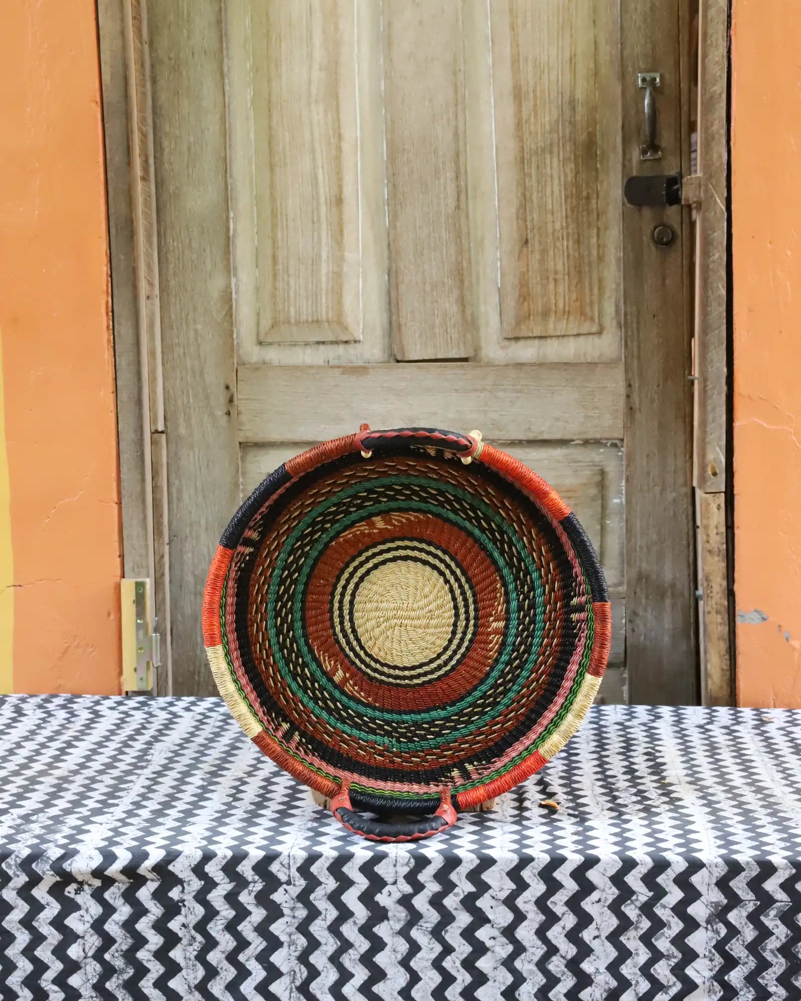 Woven Tray Wall Decor (small) by The Baba Tree. Premium elephant grass tray with leather handles. Bolgatanga artisan craftsmanship.