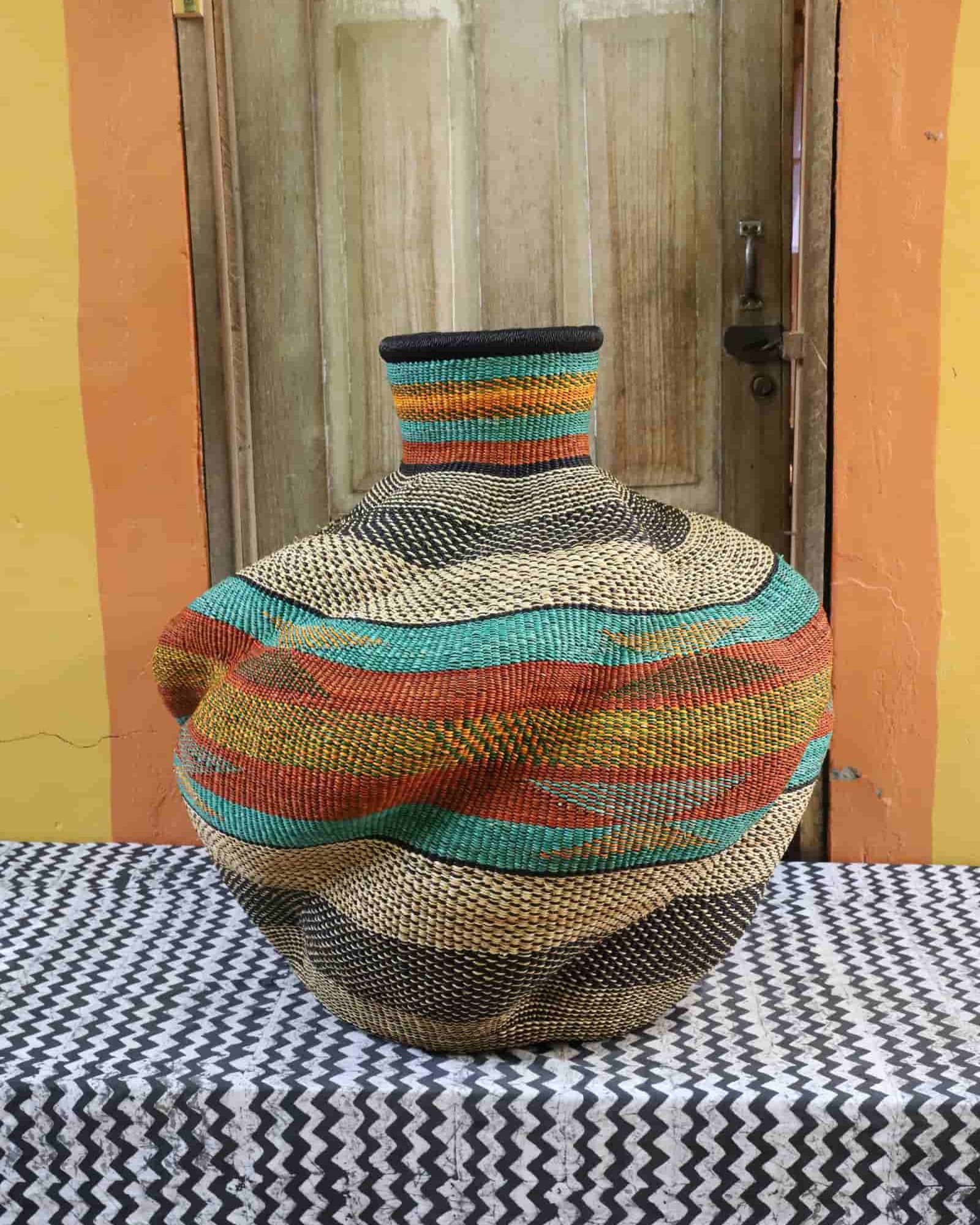 Colorful woven basket on a table with a wooden door in the background
