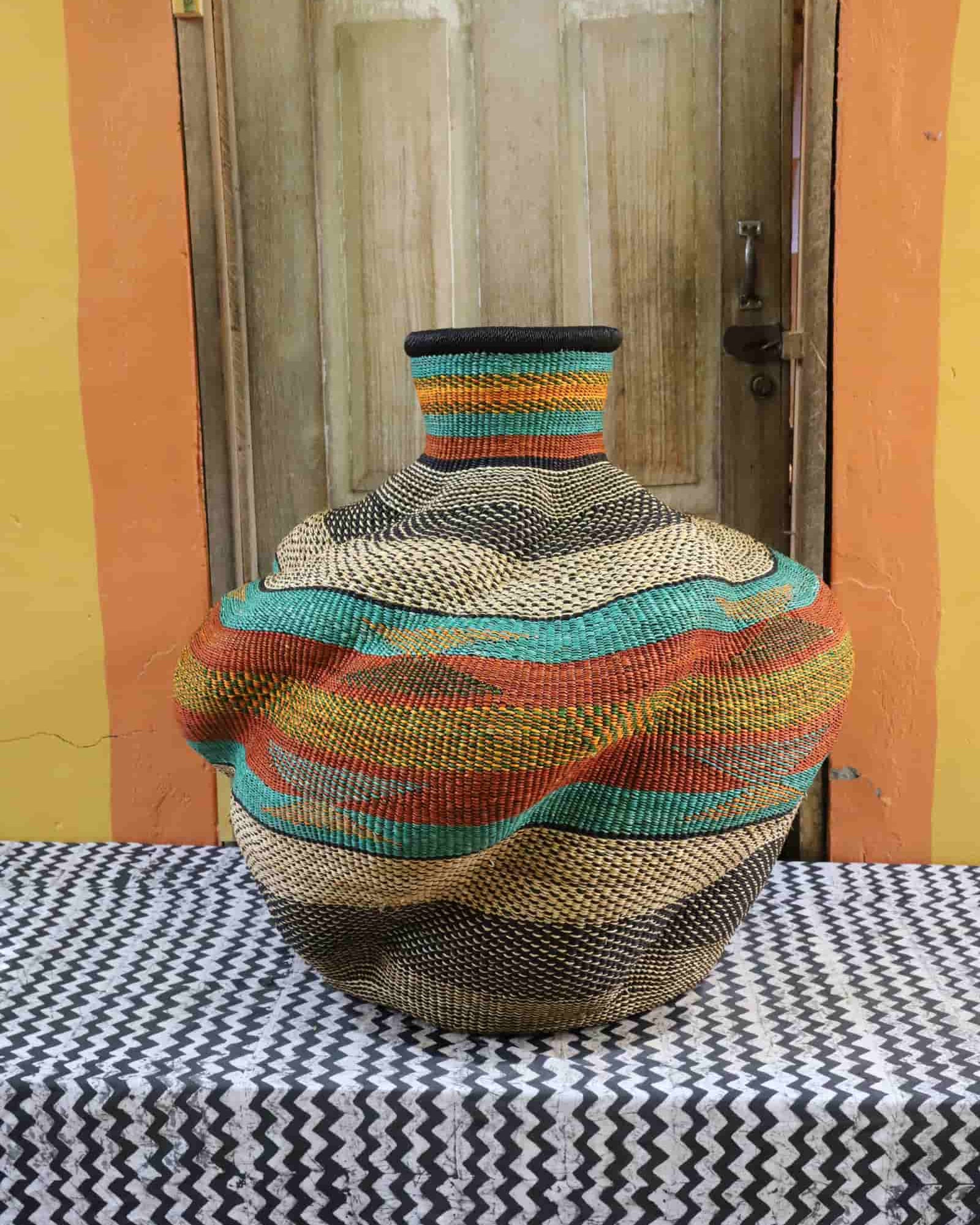 Colorful woven basket on a table with a wooden door in the background