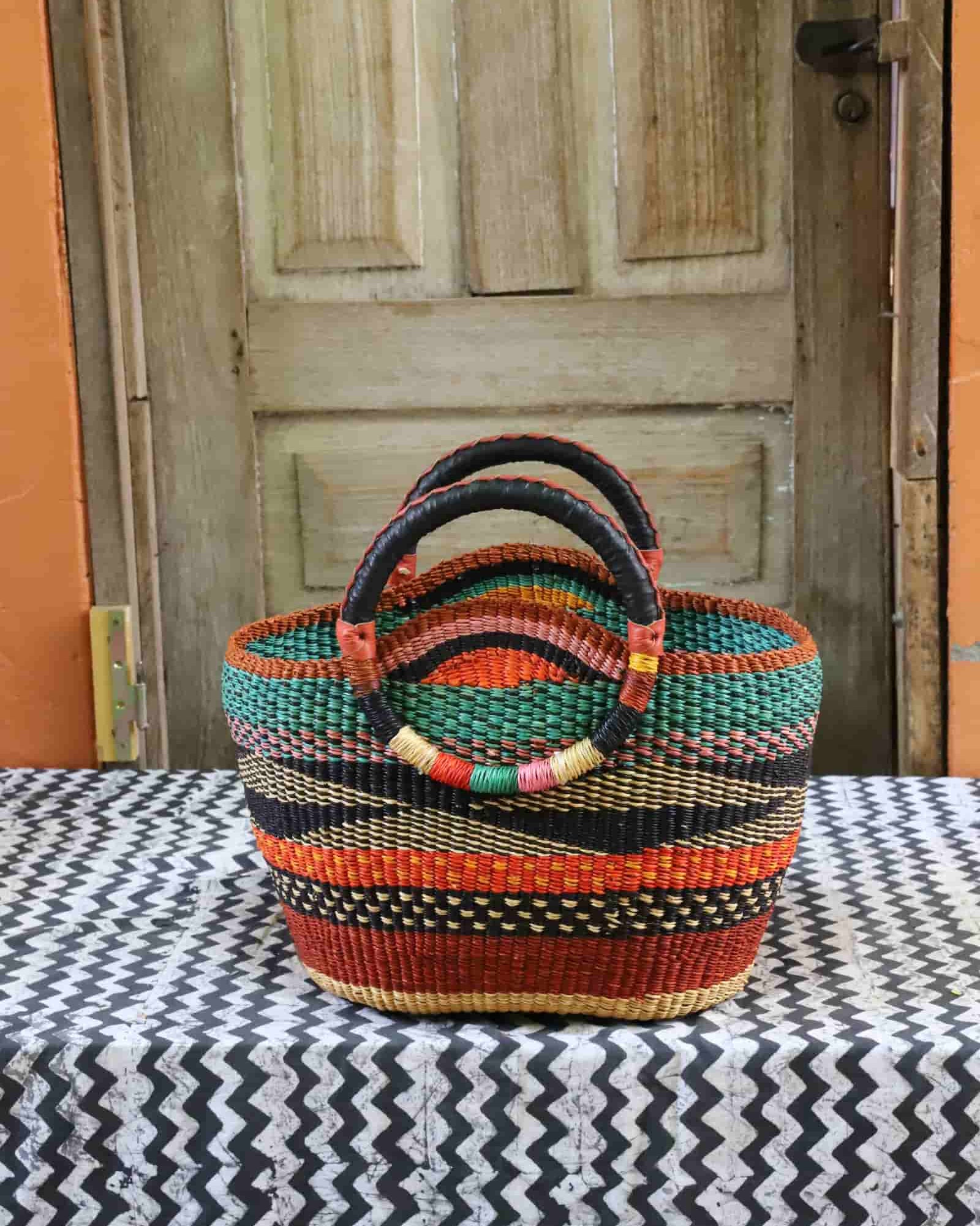 Colorful woven basket on a table with a wooden door in the background