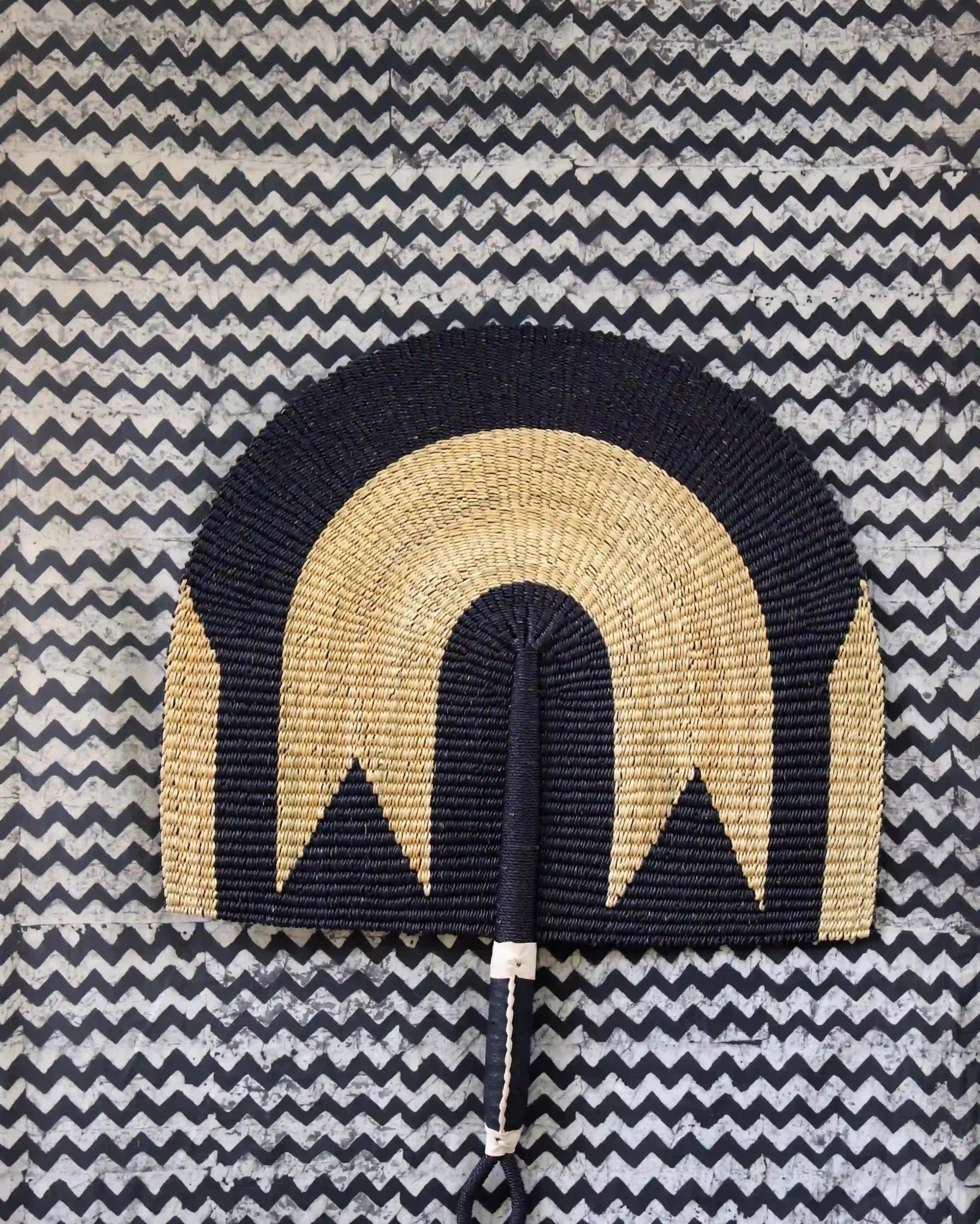 The Baba Tree Bolga Original Fan: Handwoven architectural wall art with intricate weave and premium leather handle.