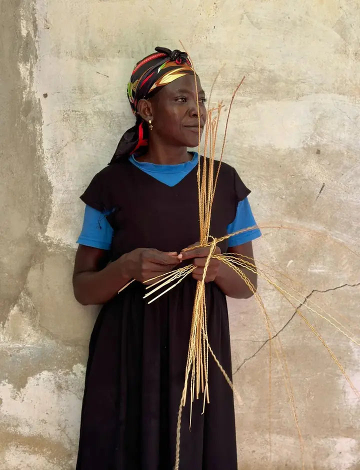A basket maker separating prepared strands of straw