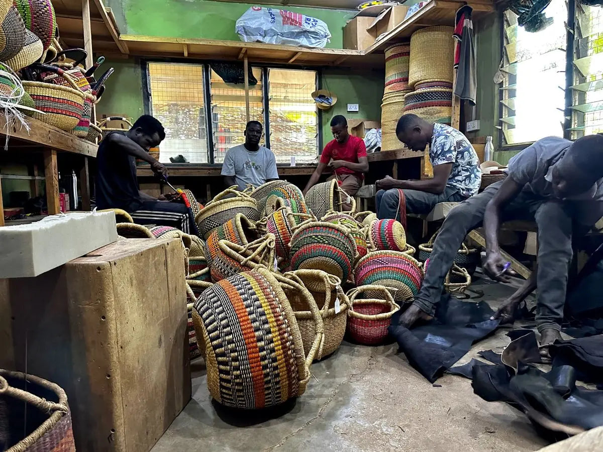The Baba Tree leather team working among finished baskets in the leather room