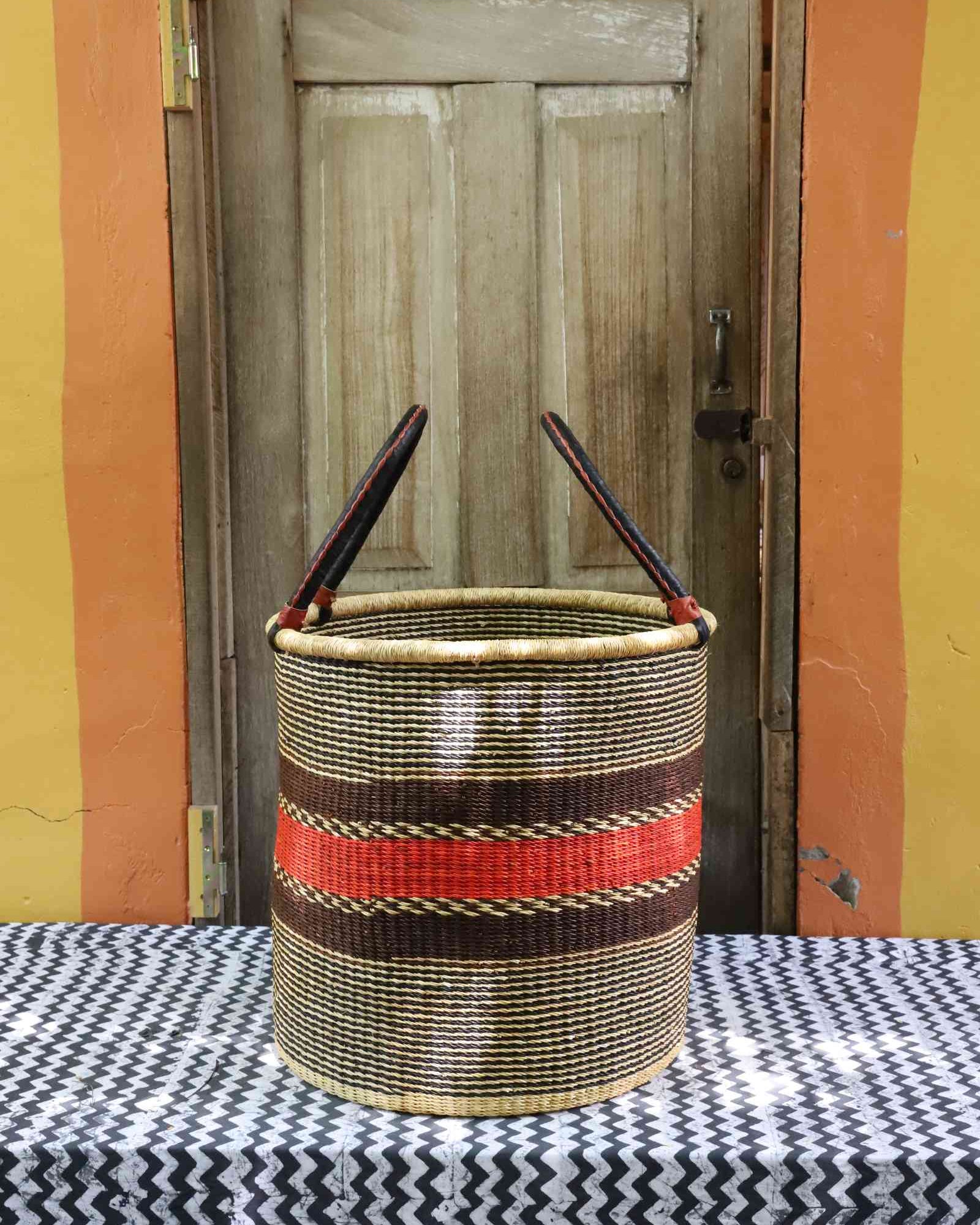Large open laundry basket handwoven in elephant grass, 51 cm wide and 51 cm tall.