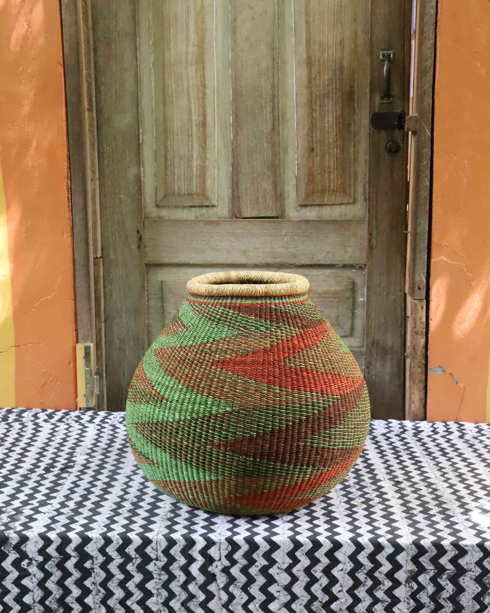 Handwoven Bolga basket with bold zigzag and diamond woven geometric pattern