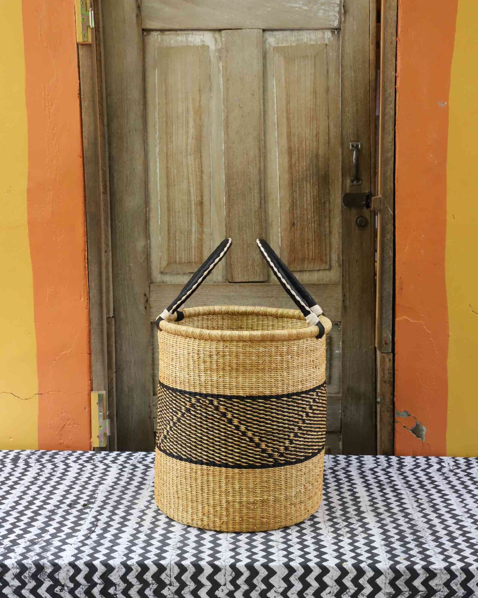 Handwoven African basket for laundry in elephant grass, open topped for daily use.