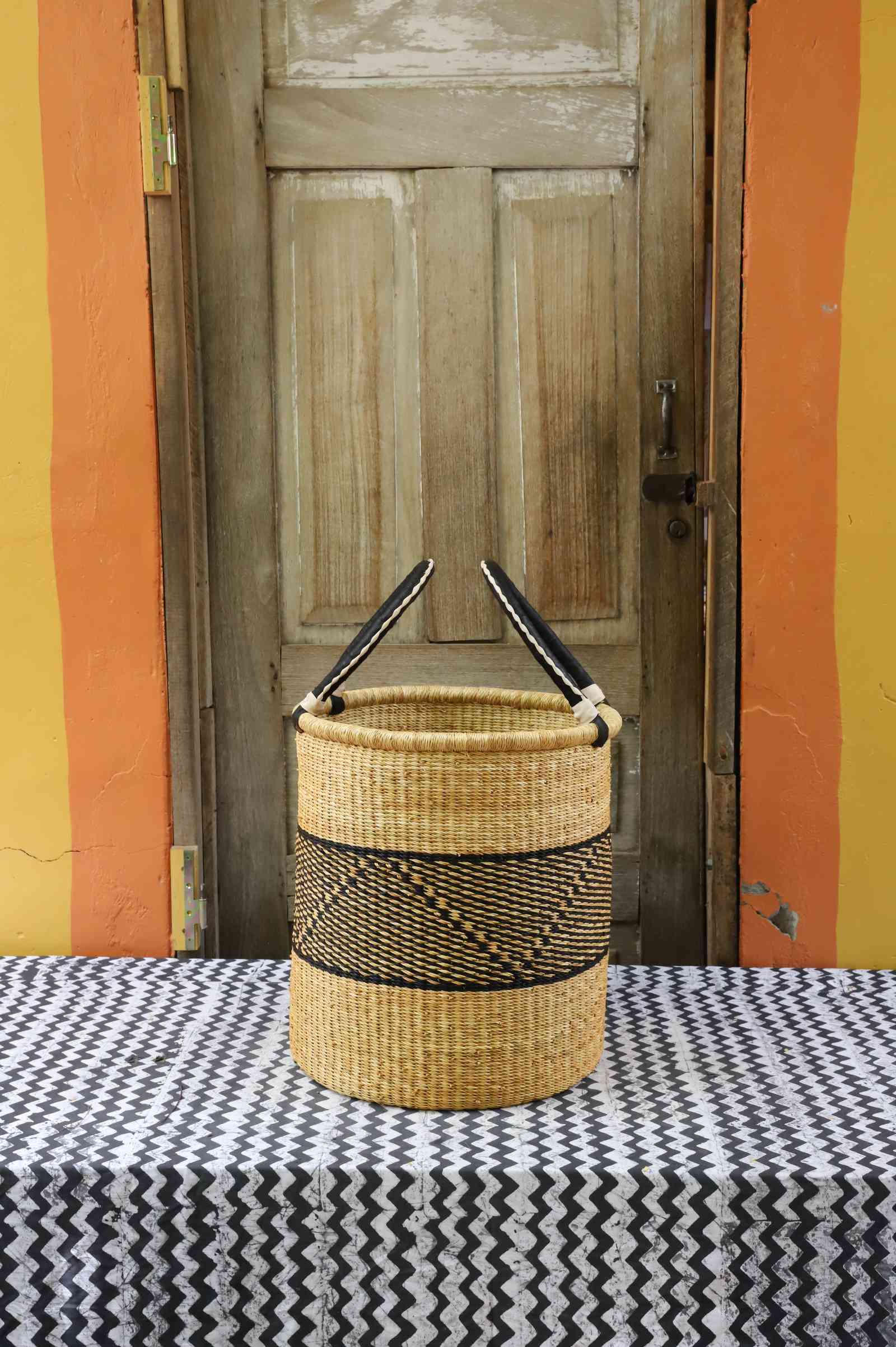 Handwoven African basket for laundry in elephant grass, open topped for daily use.