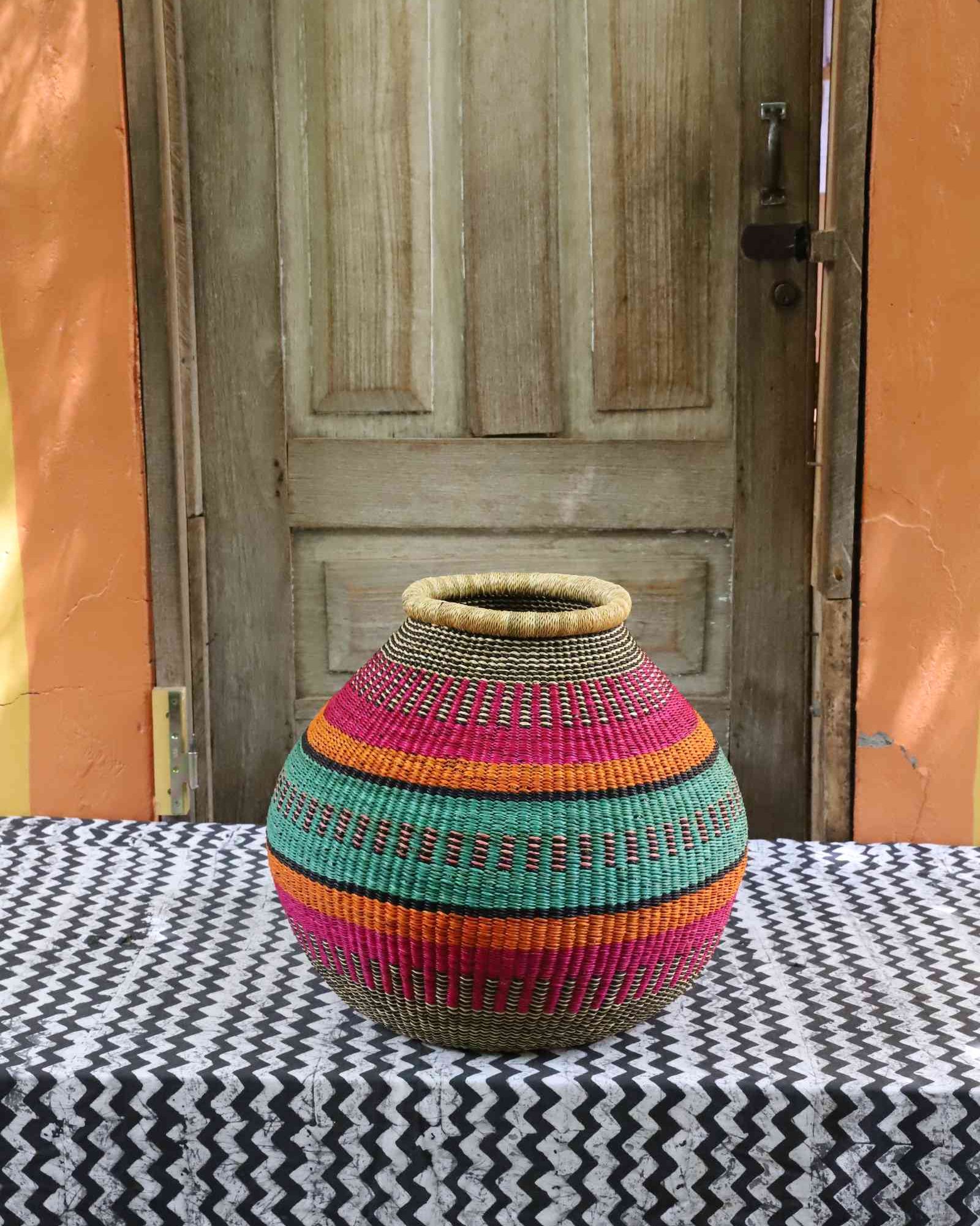 Wide handwoven Bolga basket with bold geometric woven pattern in natural elephant grass