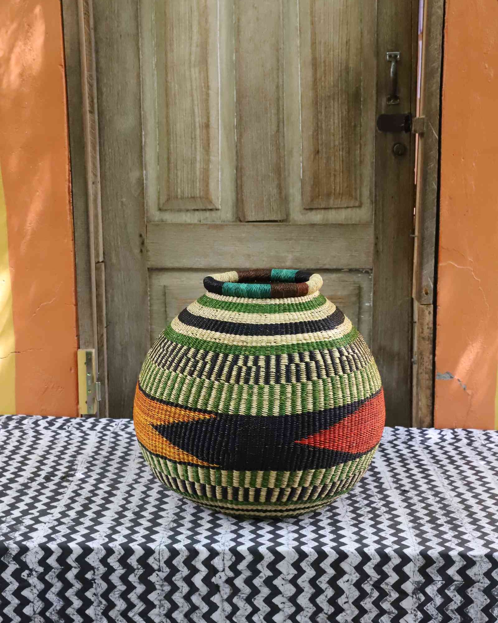 Handwoven round Bolga basket with bold colourful geometric pattern