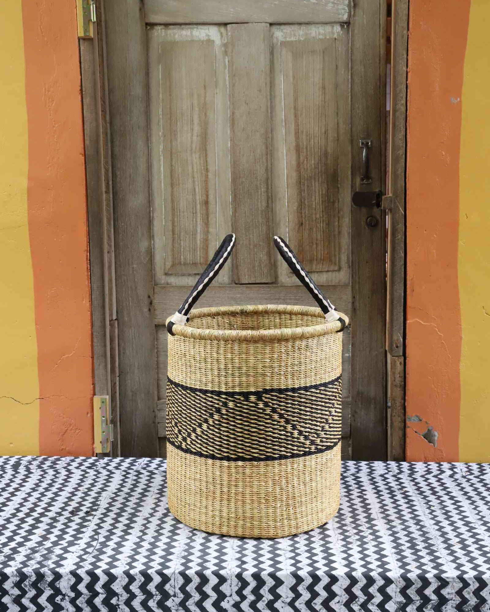 Open laundry basket handwoven from elephant grass, 43 cm wide and 46 cm tall.
