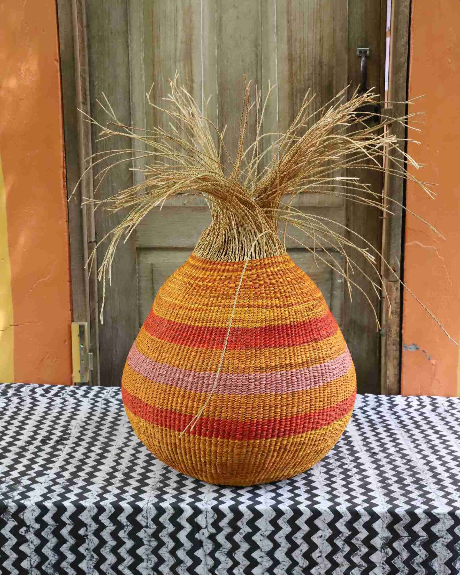Large handwoven Bolga basket with geometric woven pattern in natural grasses