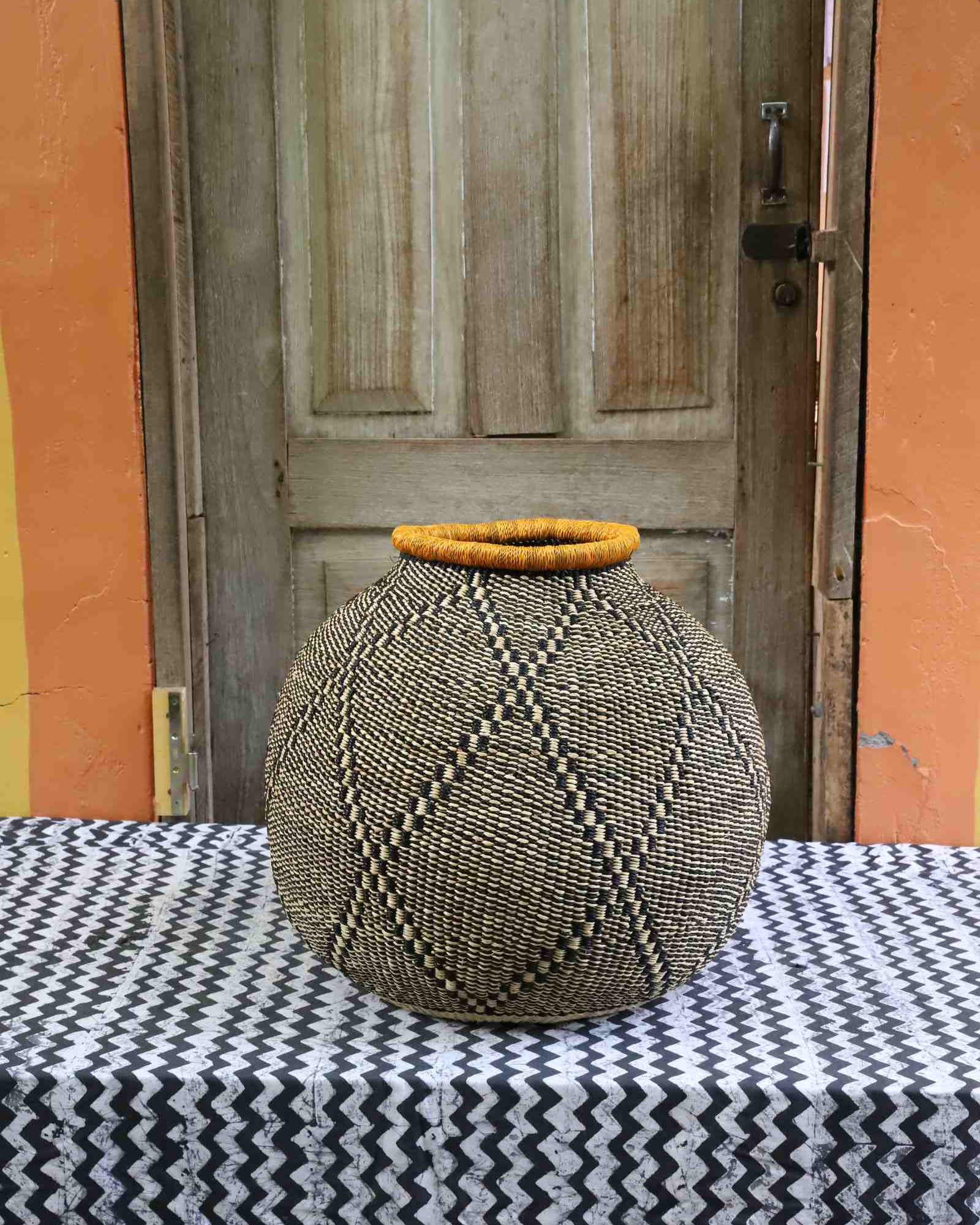 Handwoven Bolga basket with wide urn shape and bold geometric woven design