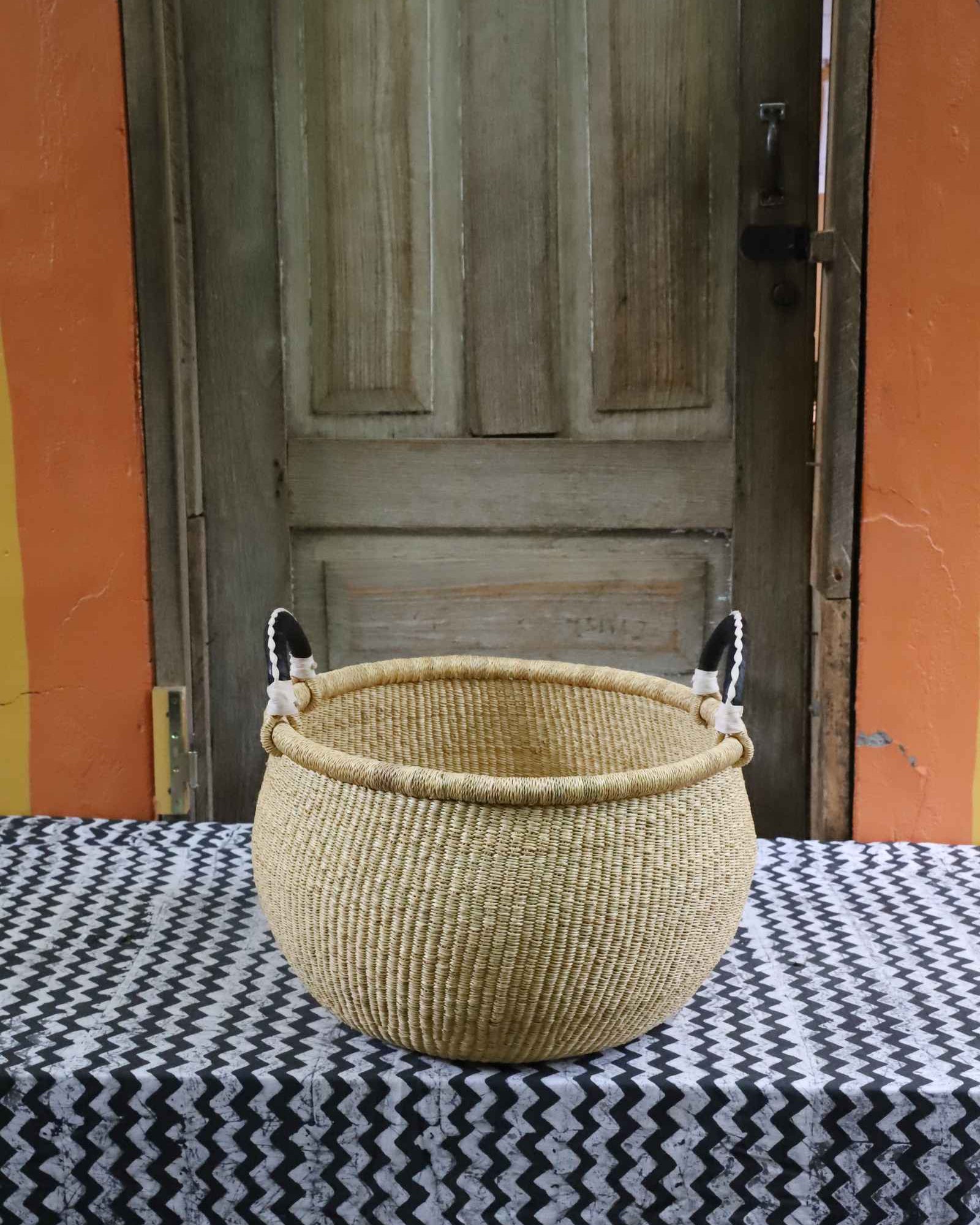 Large round handwoven Gbenka storage basket with leather handle