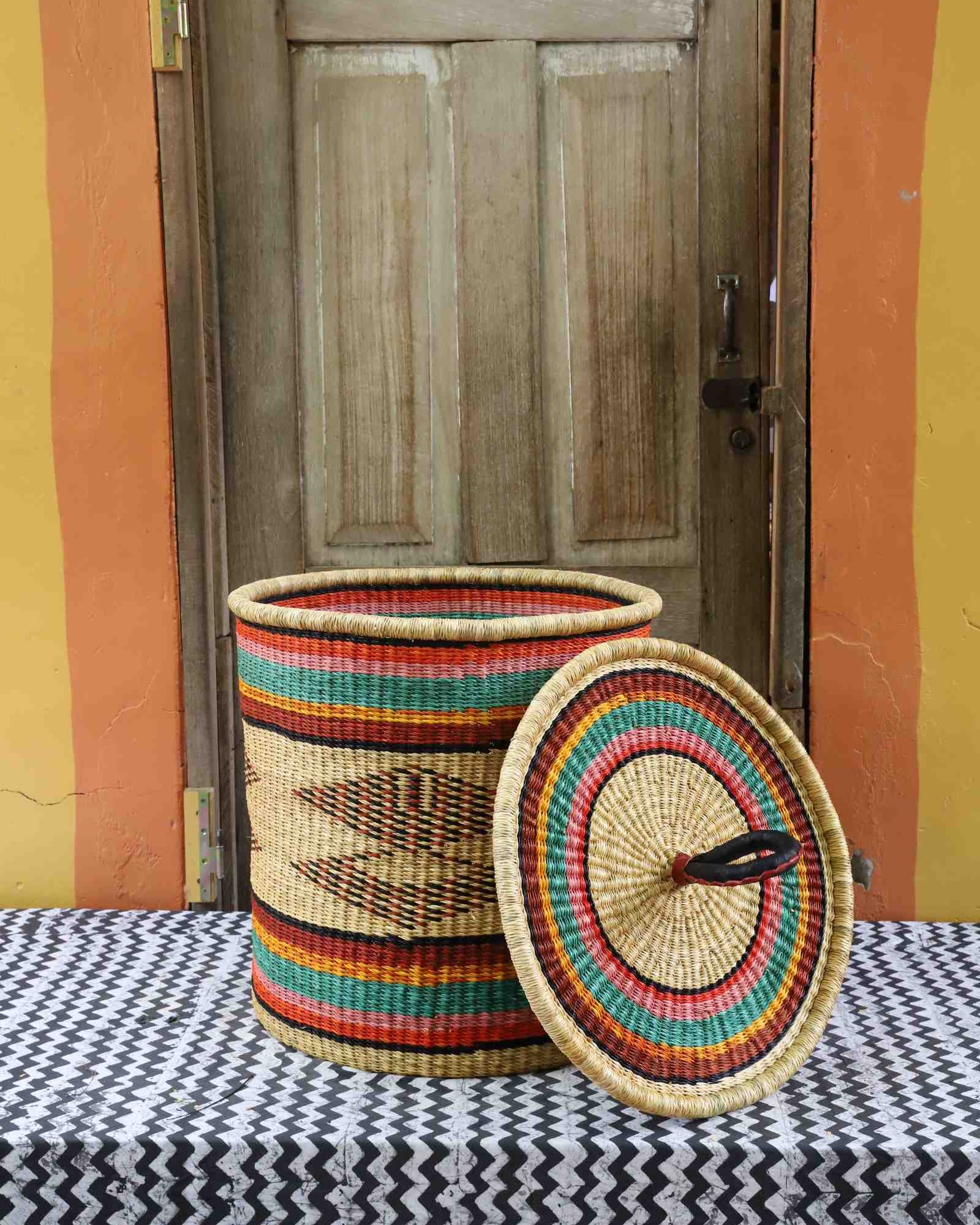 Handwoven Bolga laundry basket with lid removed, natural body with fine multicolour bands and matching lid.