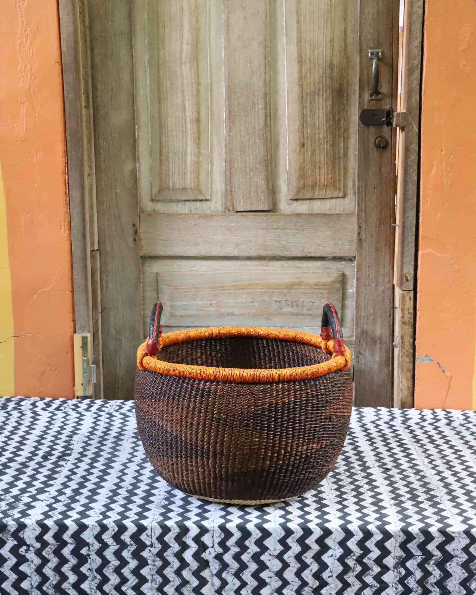Medium round handwoven Gbenka storage basket with leather handle