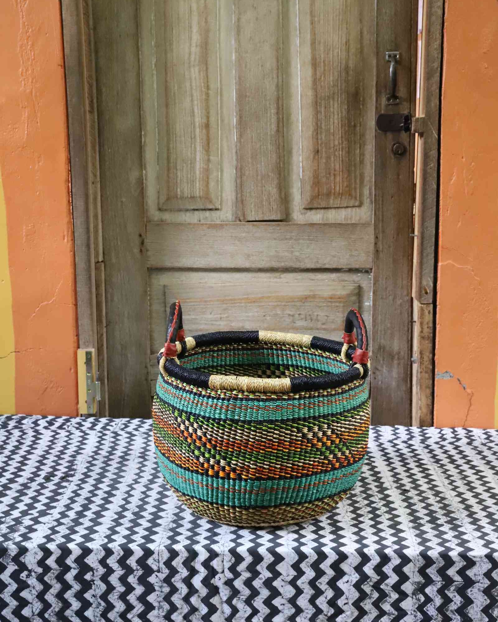 Medium handwoven Bolga storage basket with woven lid and leather handle