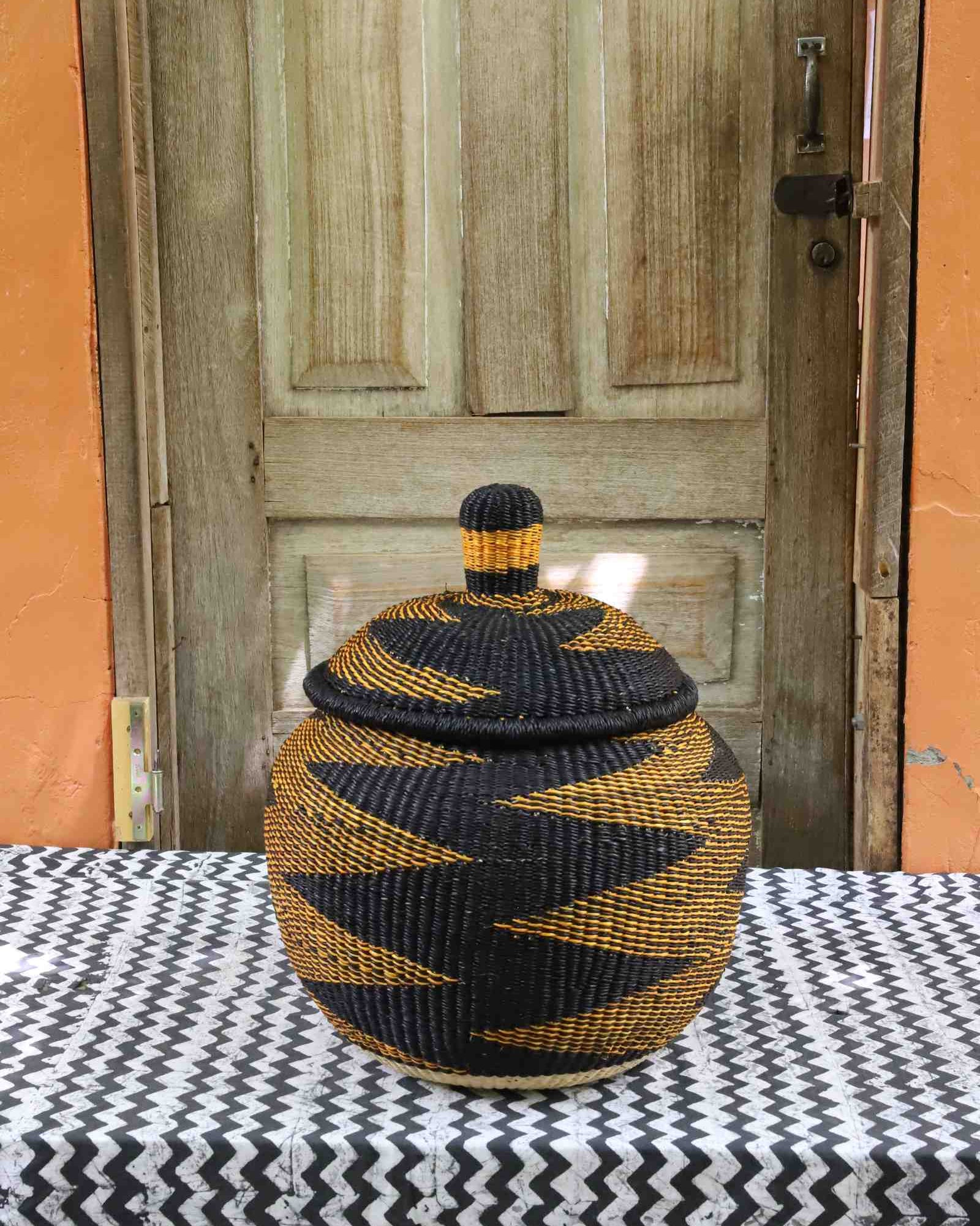 Handwoven Bolga storage basket, round medium, globe-shaped form