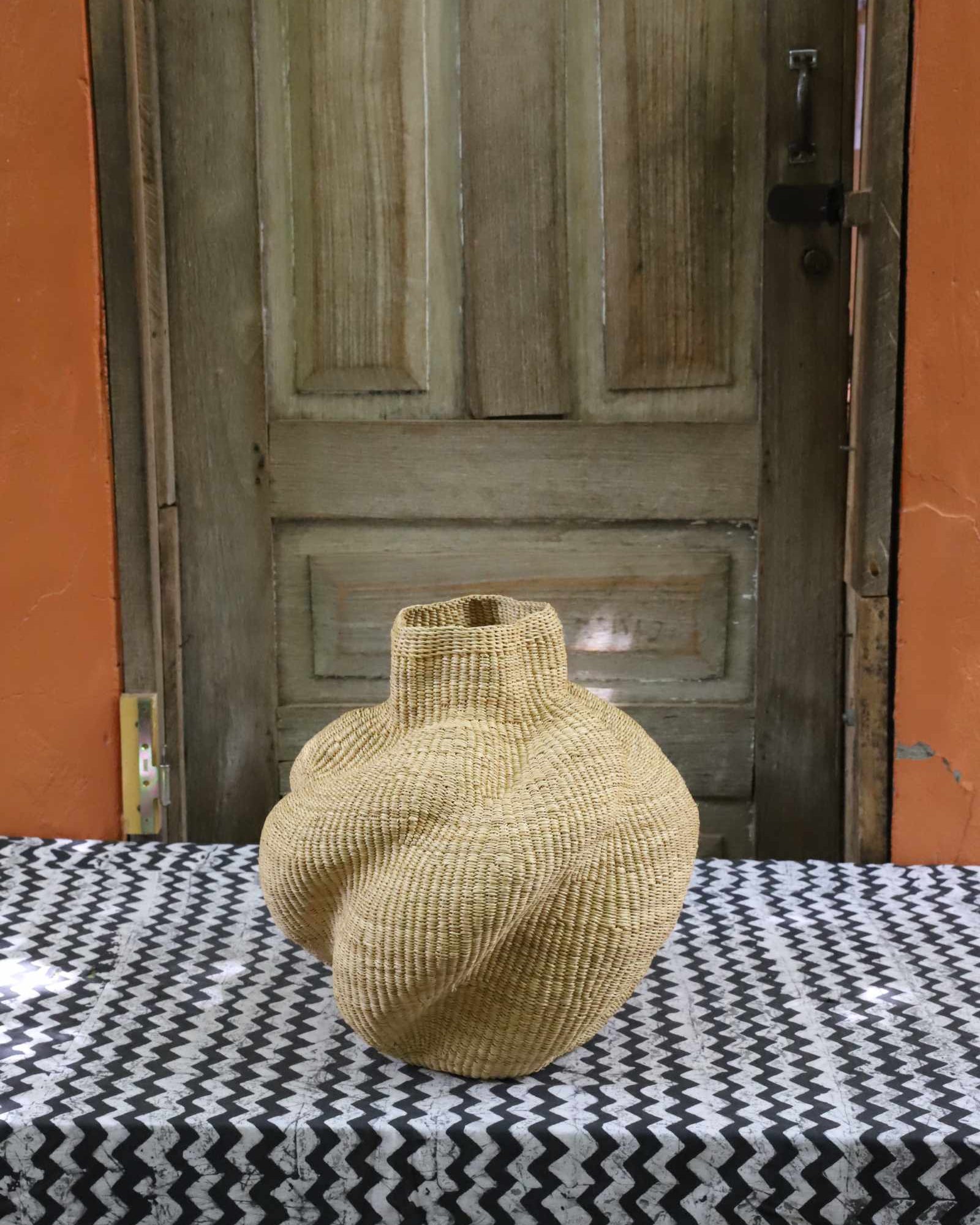 Small sculptural handwoven Bolga art basket with lobed petal form