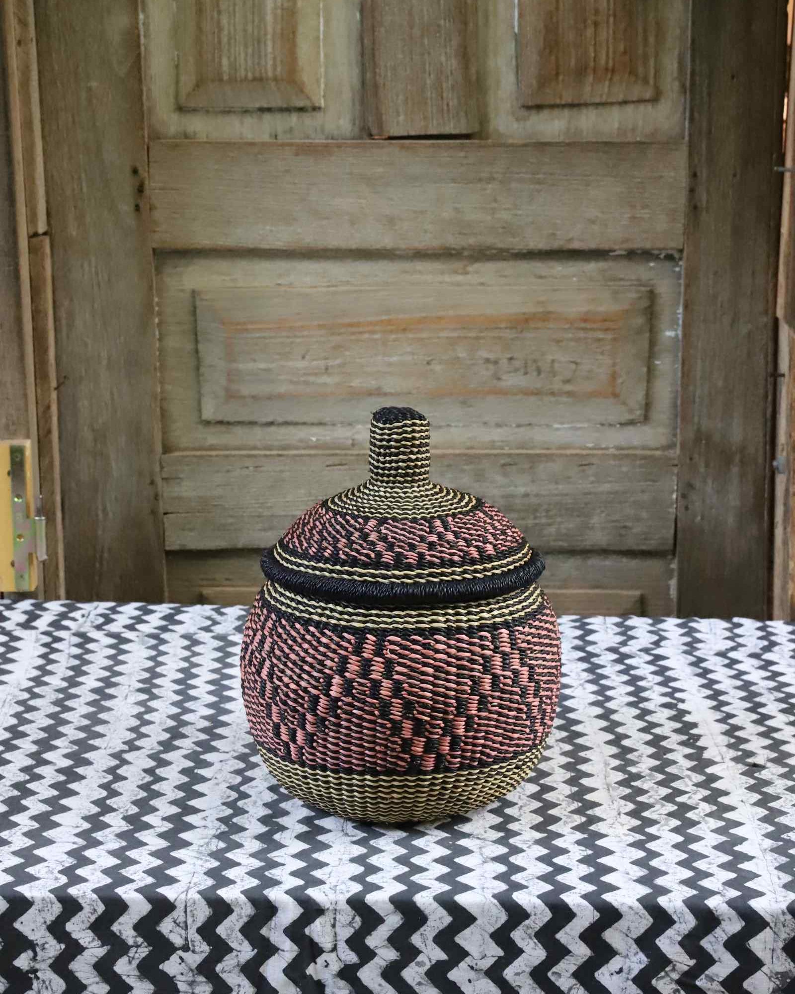 Small round globe-shaped handwoven African storage basket