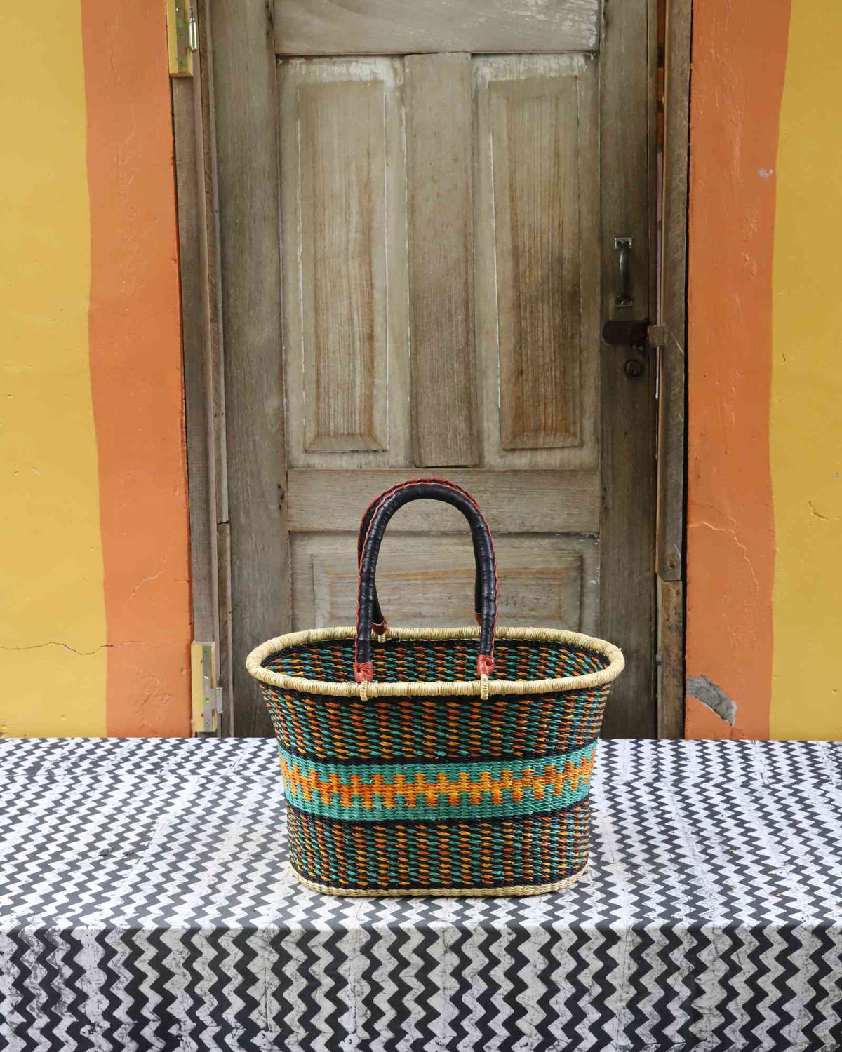 Large handwoven Bolga Zaane Tia market basket in natural straw with teal and multicolour fine banded stripes.