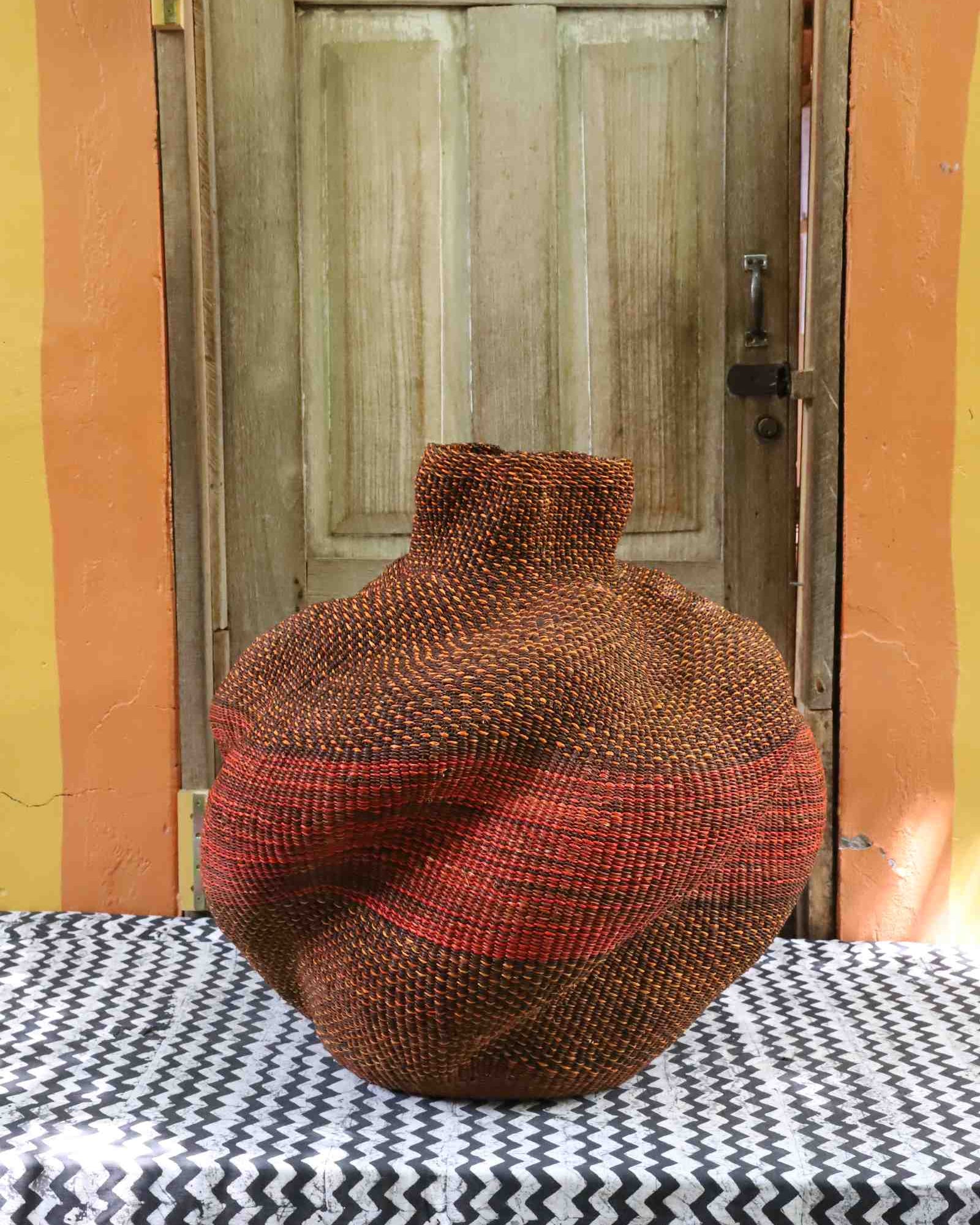 Medium sculptural handwoven Bolga art basket with lobed form