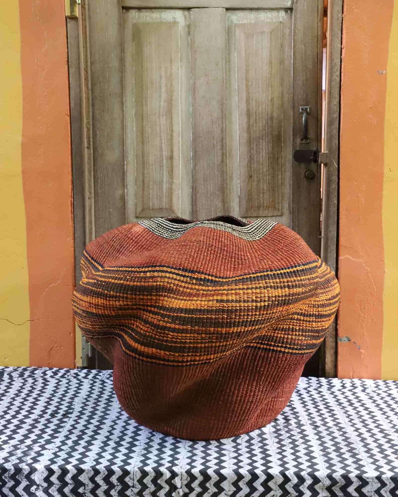 Sculptural handwoven Bolga art basket in natural woven grass