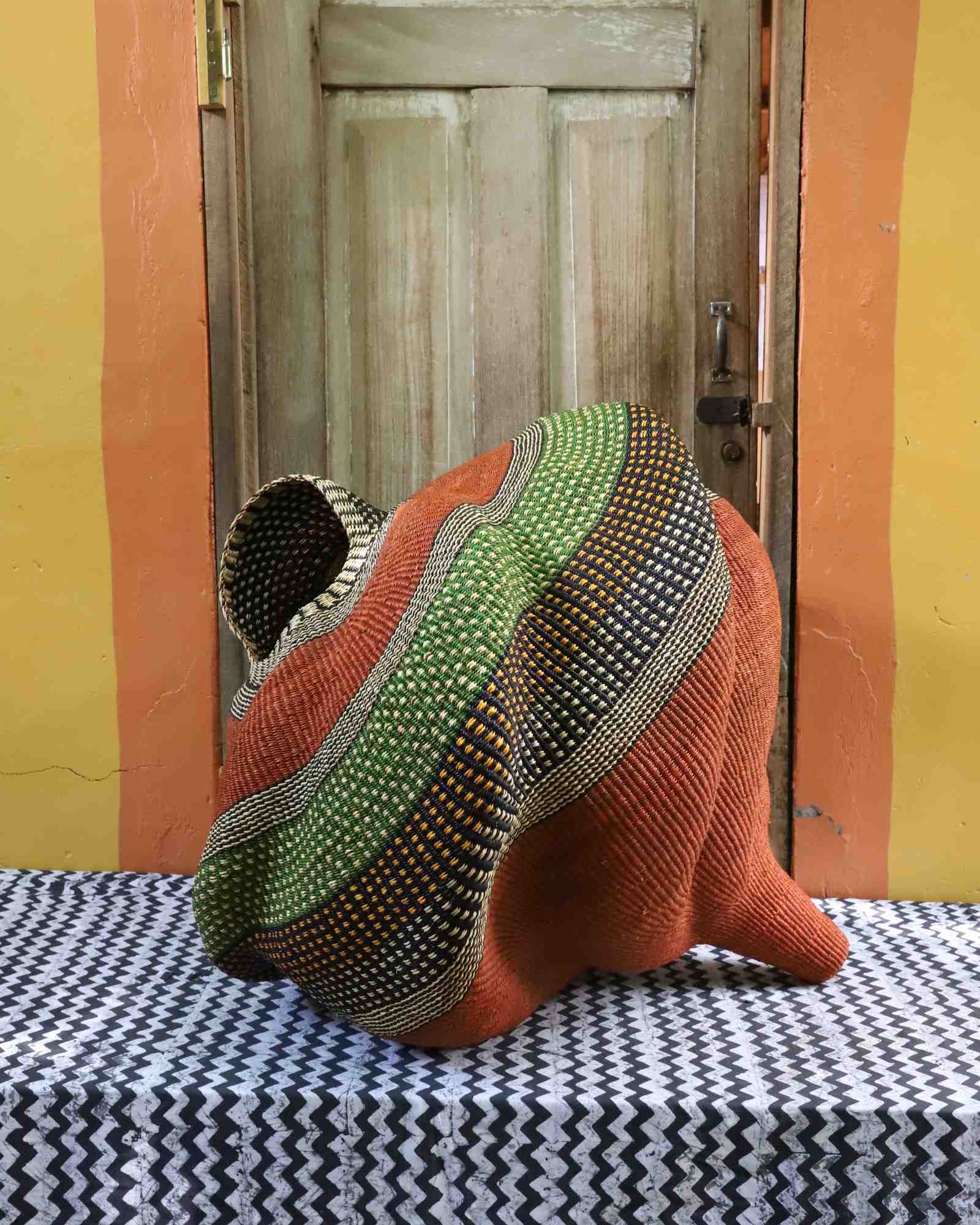 Large handwoven Bolga art basket in a sculptural conch shell form
