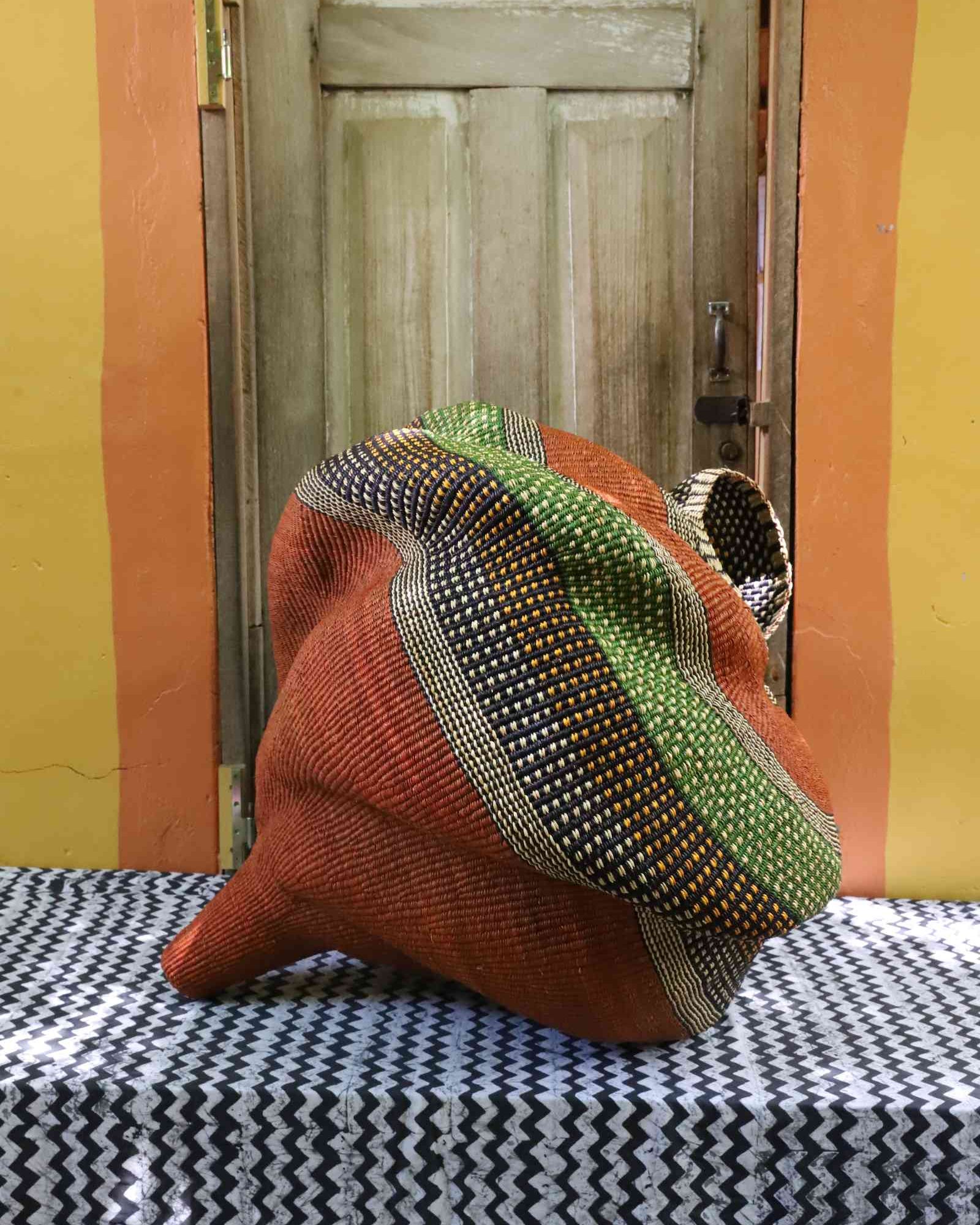Large Katayeli-tia conch-form Bolga basket, side angle view