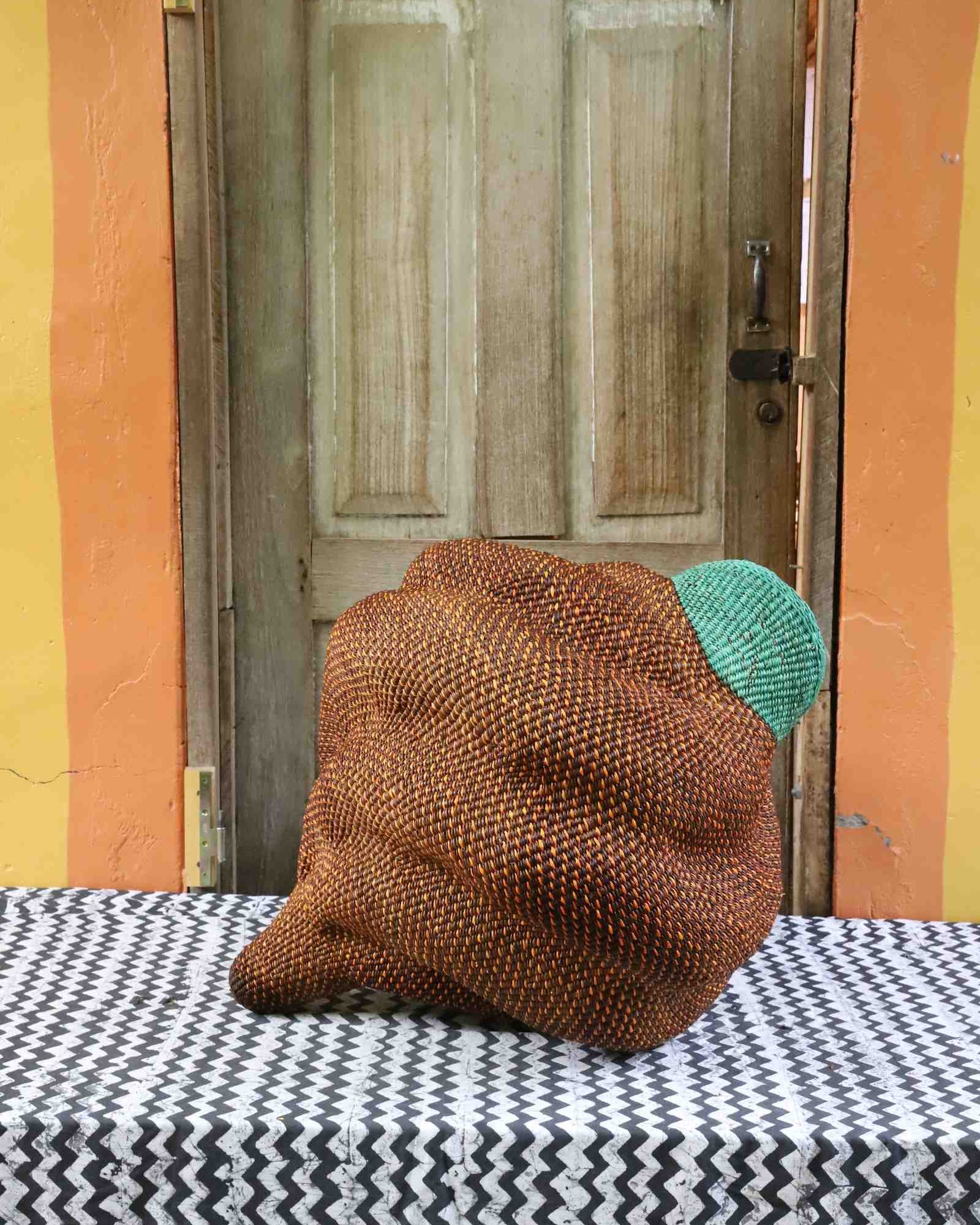 Handwoven Bolga art basket with conch shell form, medium size