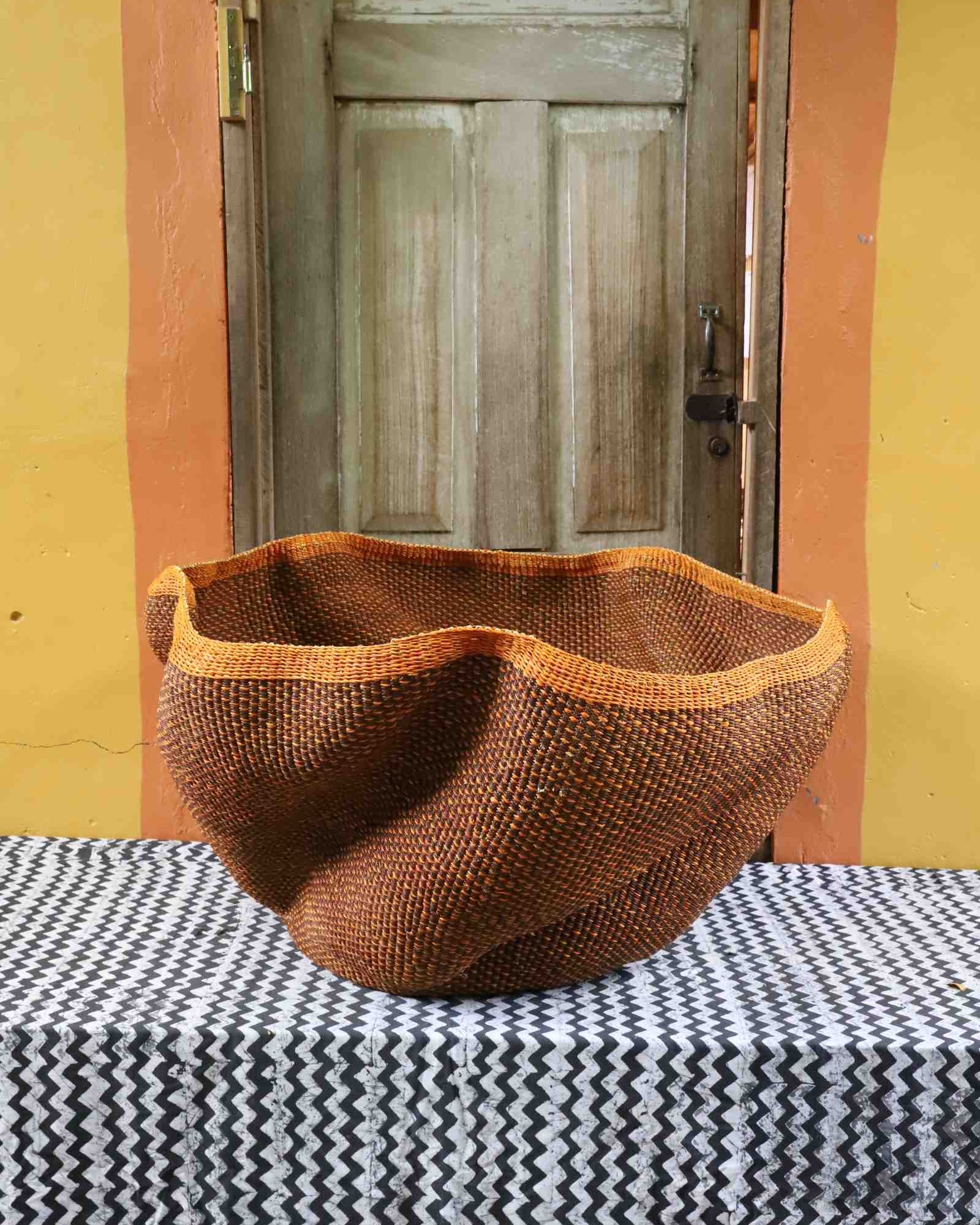 Handwoven Bolga art basket with dramatic wave-shaped sculptural form