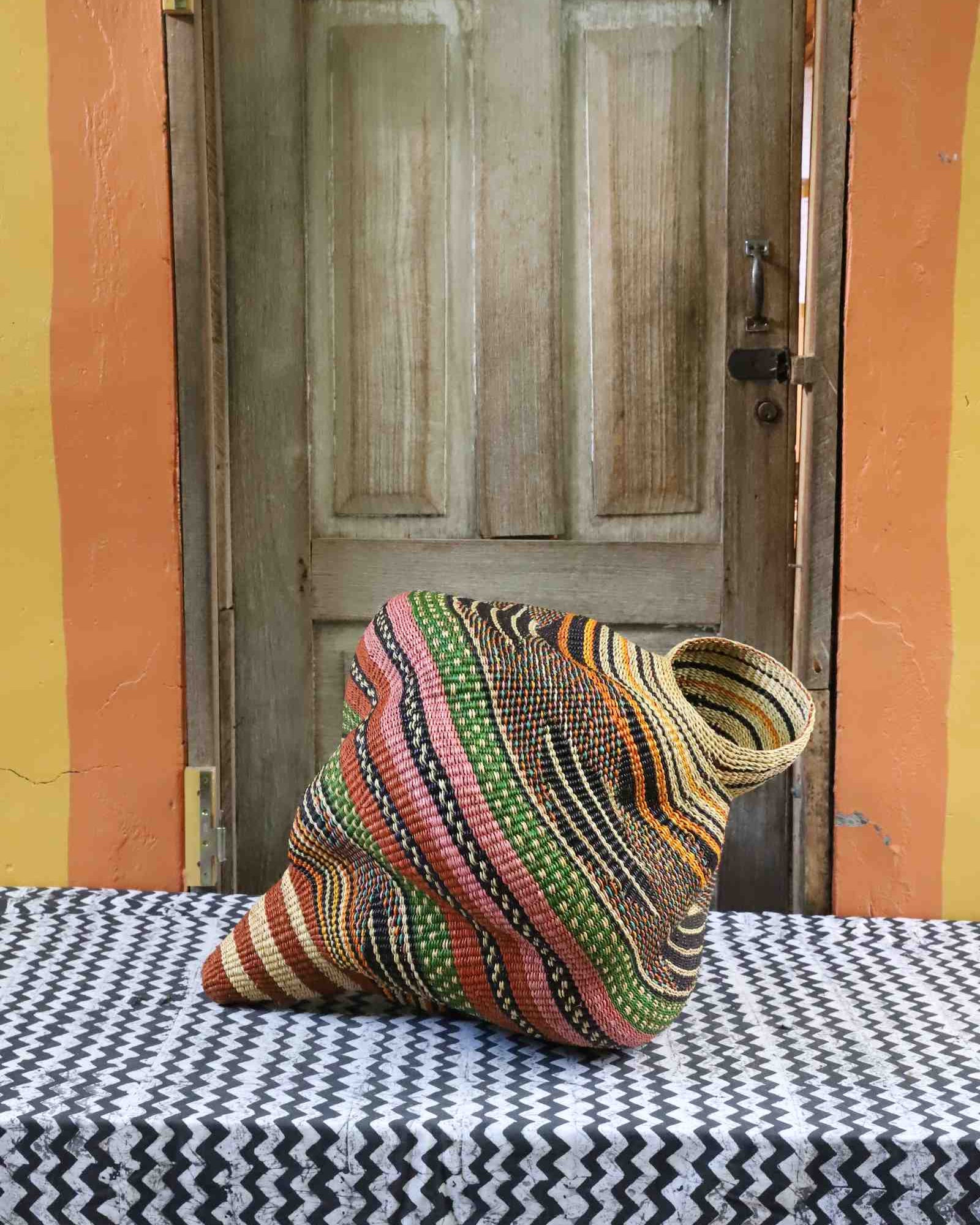 Medium handwoven Bolga art basket in a conch shell sculptural form