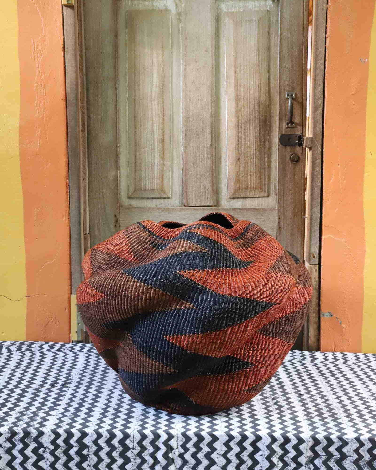 Handwoven Bolga art basket in sculptural woven form