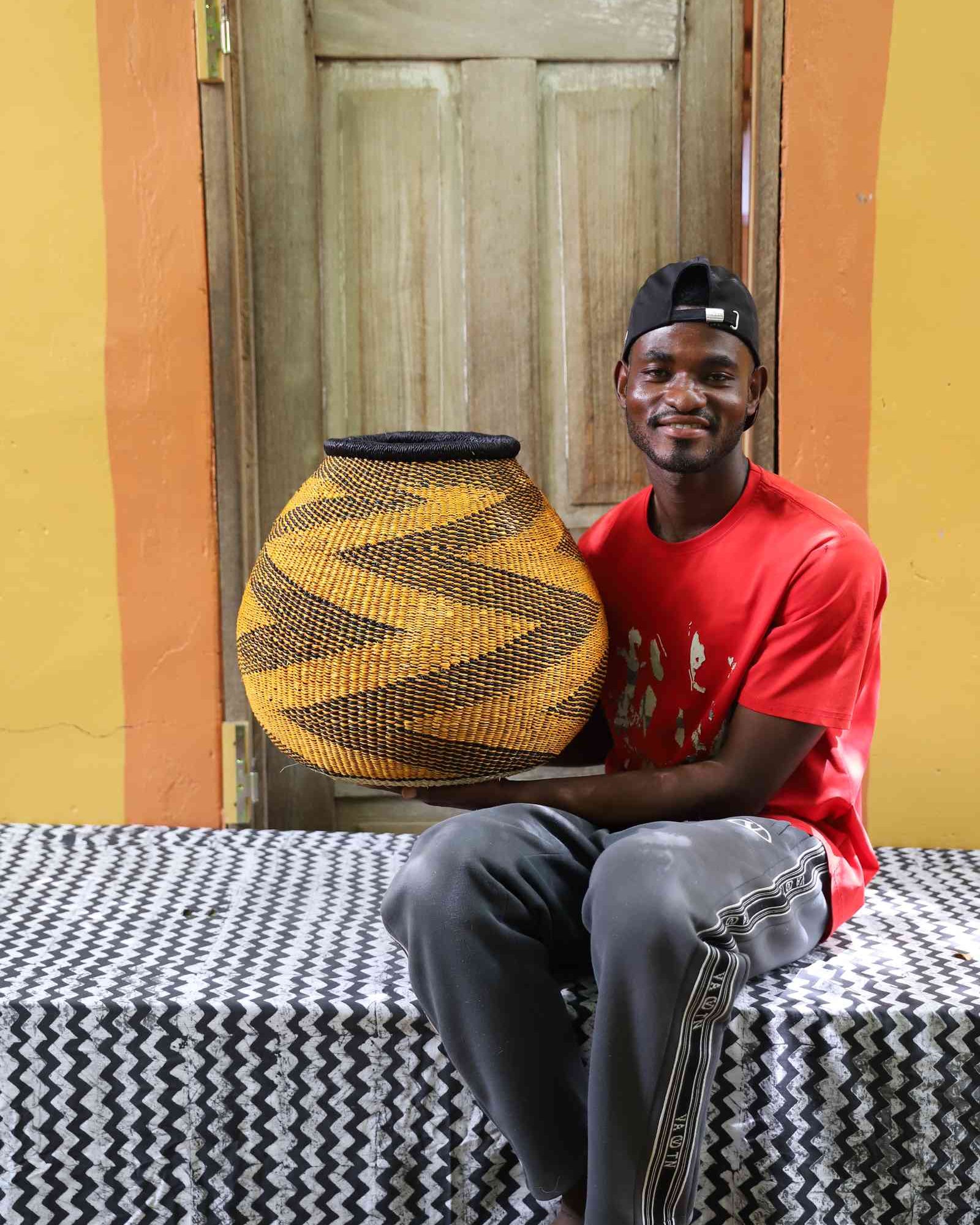 Round handwoven African basket with geometric pattern as home Décor accent