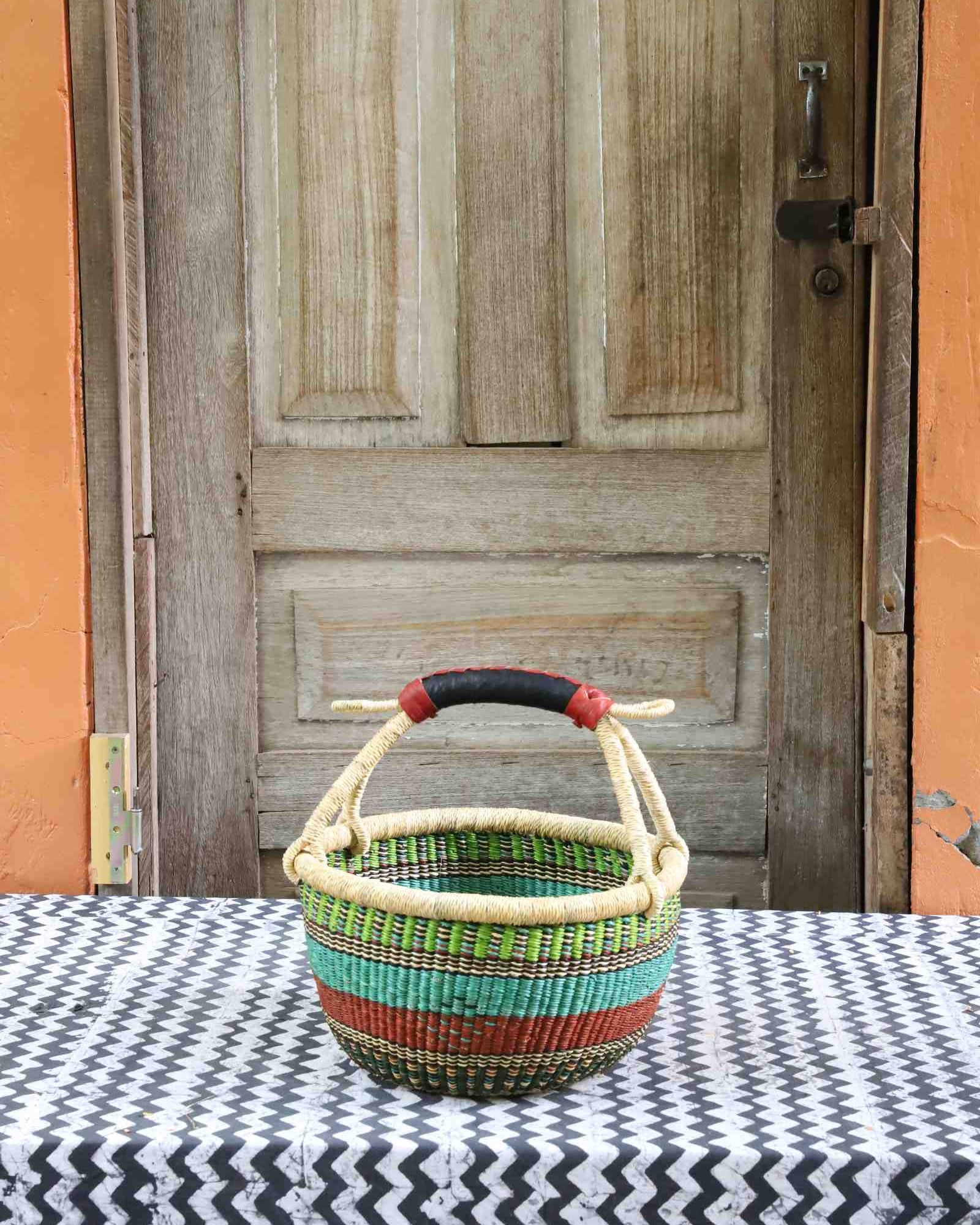 Handwoven Bolga shopping basket in elephant grass, round in form with two handles.