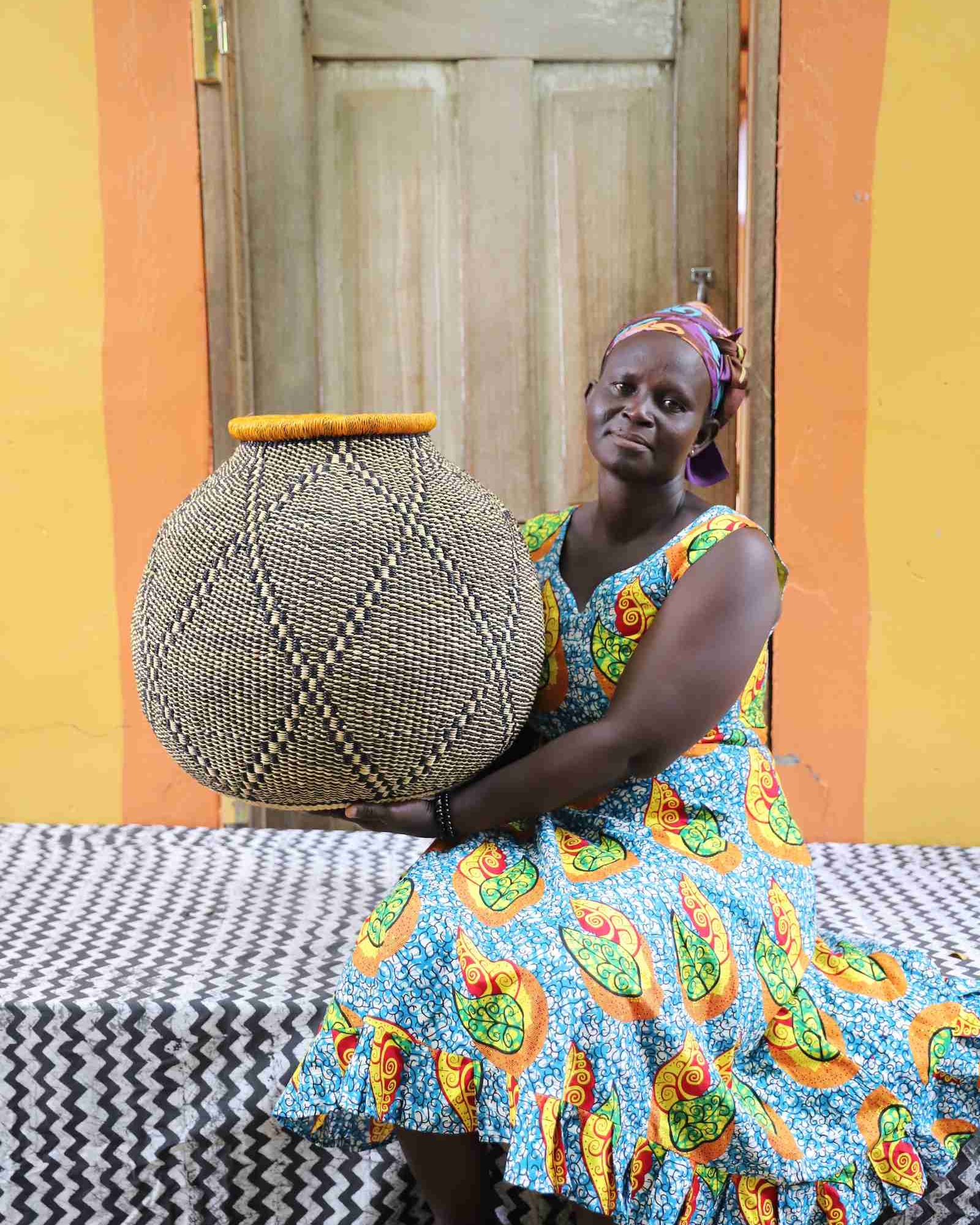 Large round handwoven African basket with geometric pattern styled indoors