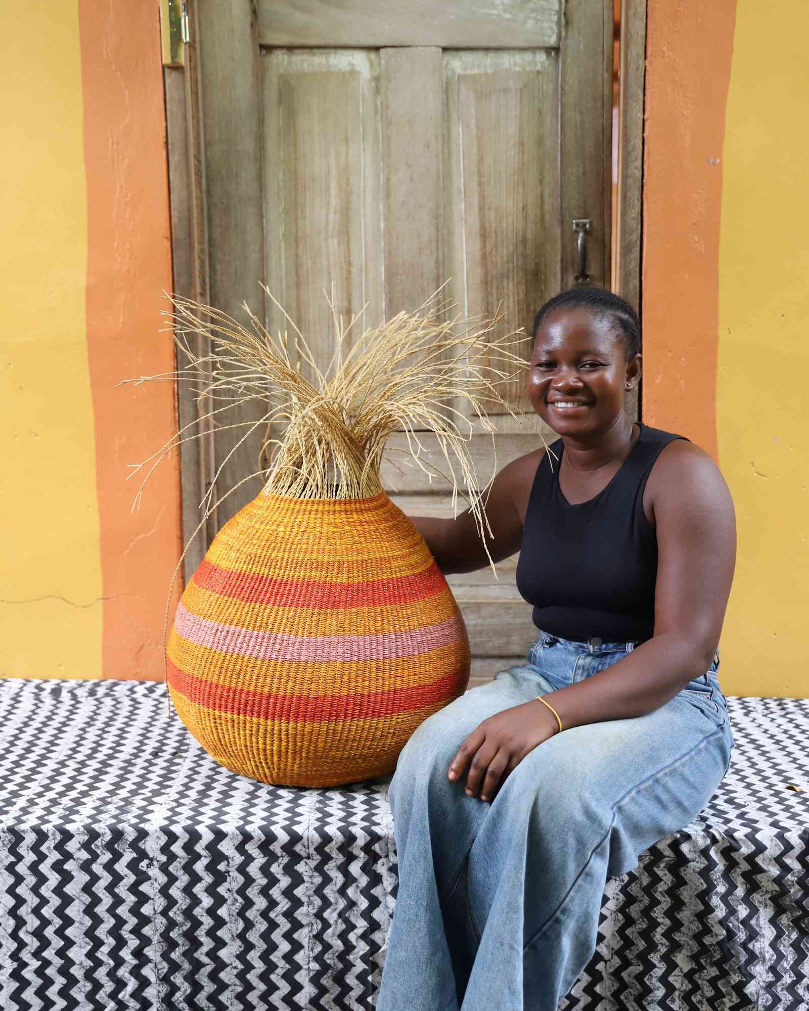 Round Bolga basket with coloured geometric pattern displayed as home Décor