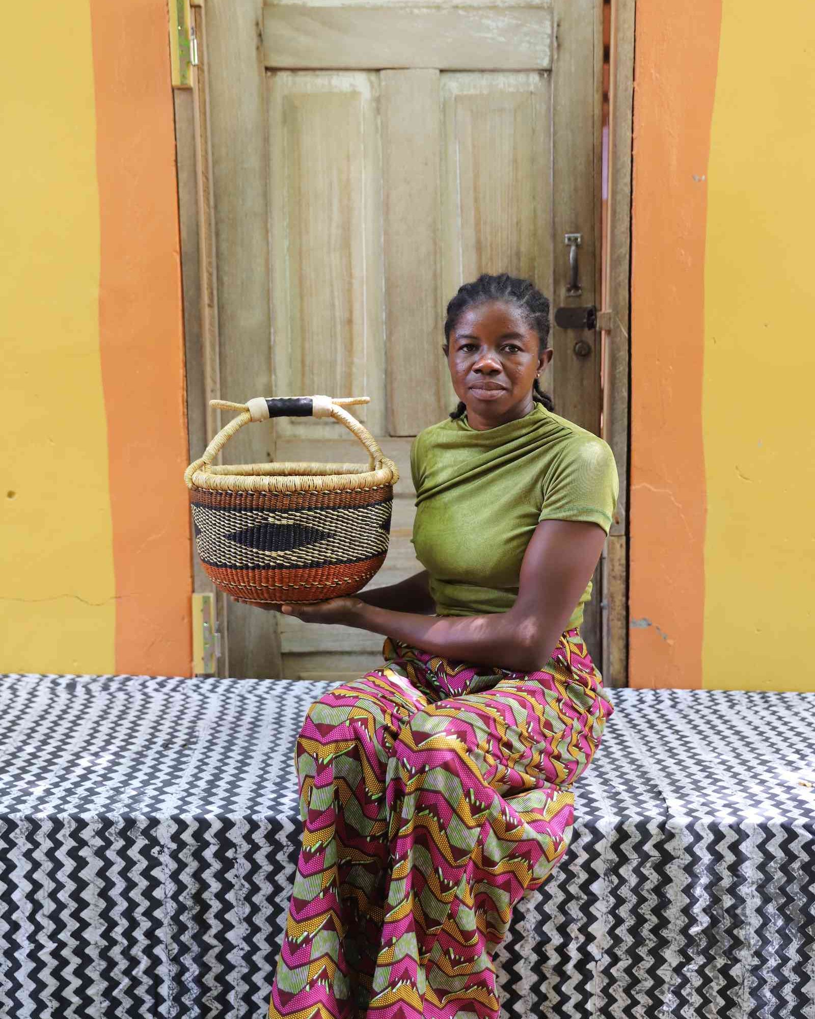 Small round handwoven African shopping basket styled in a home interior