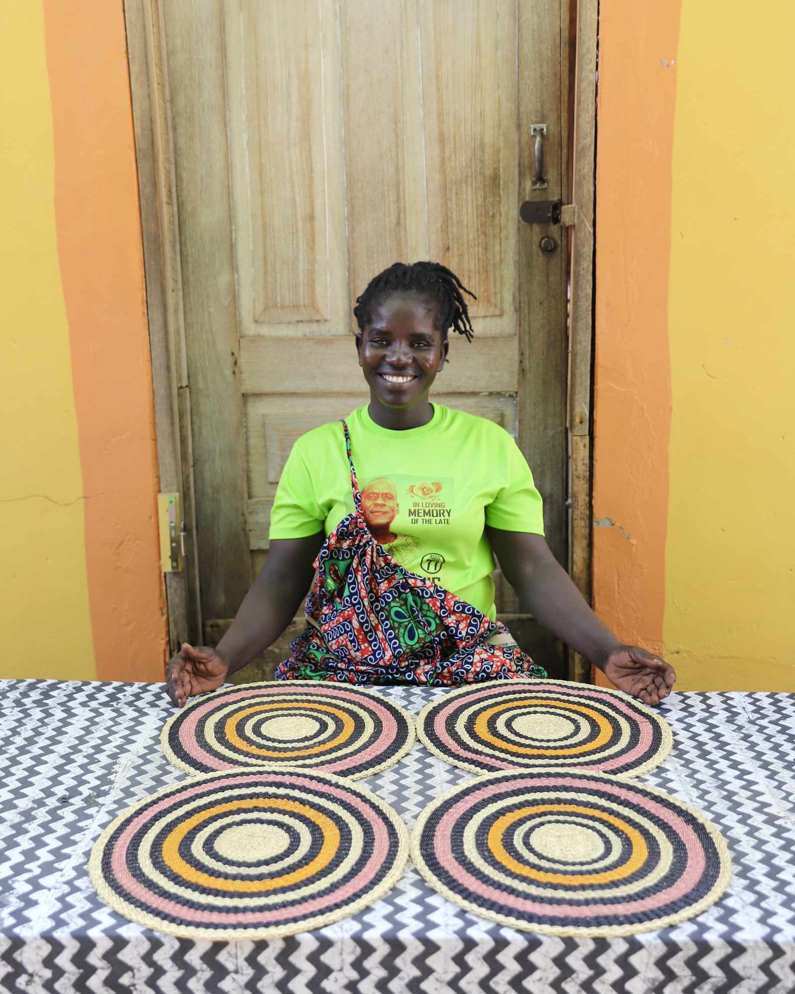 Set of four handwoven Bolga placemats in natural straw with concentric ring pattern, displayed in Bolgatanga, Ghana.
