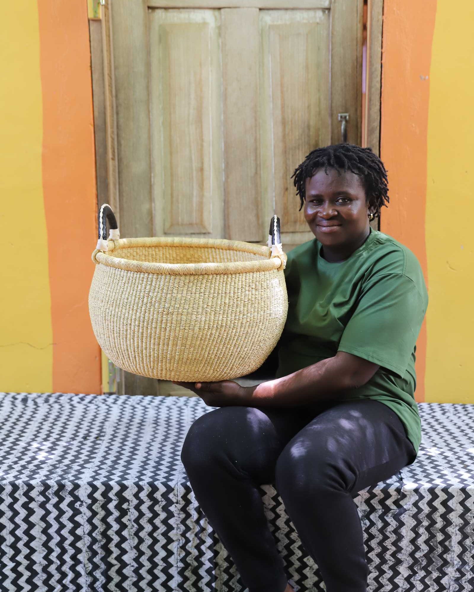 Large Gbenka handwoven storage basket in a styled home interior