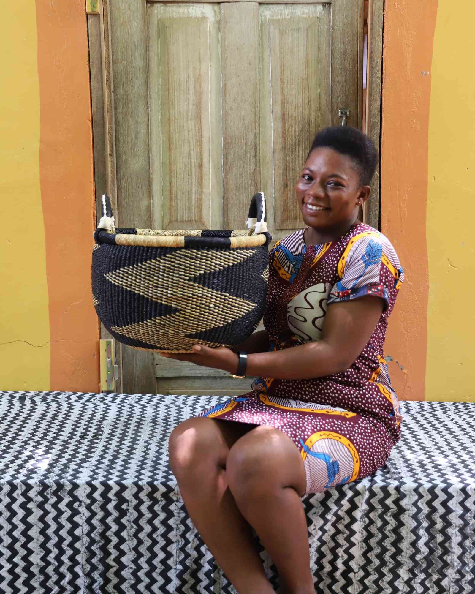Medium handwoven Bolga storage basket displayed in a home setting