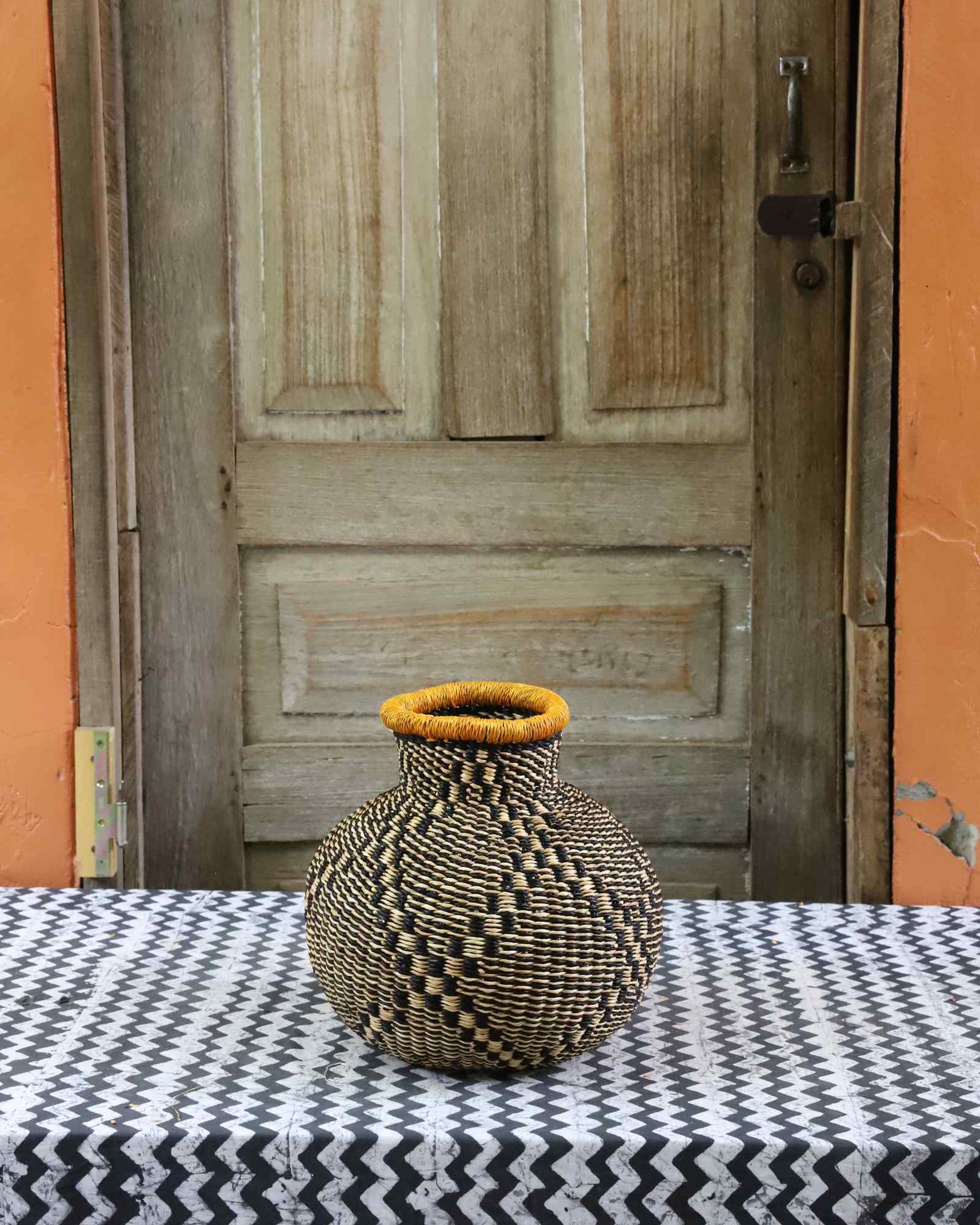 Jemima 10 Cows décor basket, a handwoven Bolga basket in elephant grass with a narrow opening.