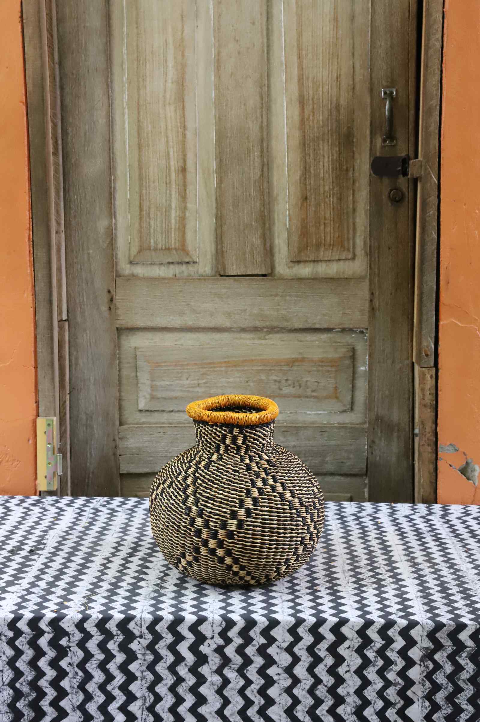 Jemima 10 Cows décor basket, a handwoven Bolga basket in elephant grass with a narrow opening.